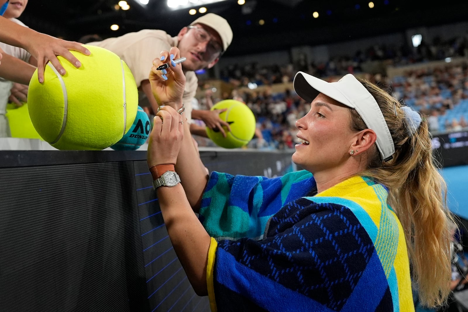 Donna Vekic of Croatia signs autographs after defeating Diane Parry of France in their first round match at the Australian Open tennis championship in Melbourne, Australia, Sunday, Jan. 12, 2025. (AP Photo/Asanka Brendon Ratnayake)