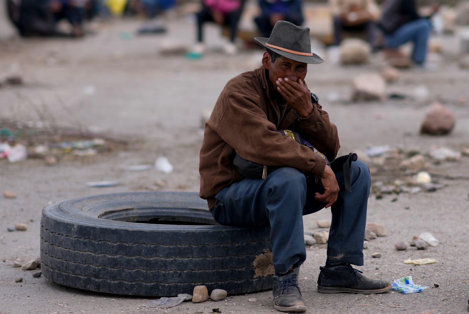 A supporter of former Bolivian President Evo Morales takes part in a road block as pressure to prevent the former leader from facing a criminal investigation over allegations for abuse of a minor, near Cochabamba, Bolivia, Saturday, Oct. 26, 2024. (AP Photo/Juan Karita)