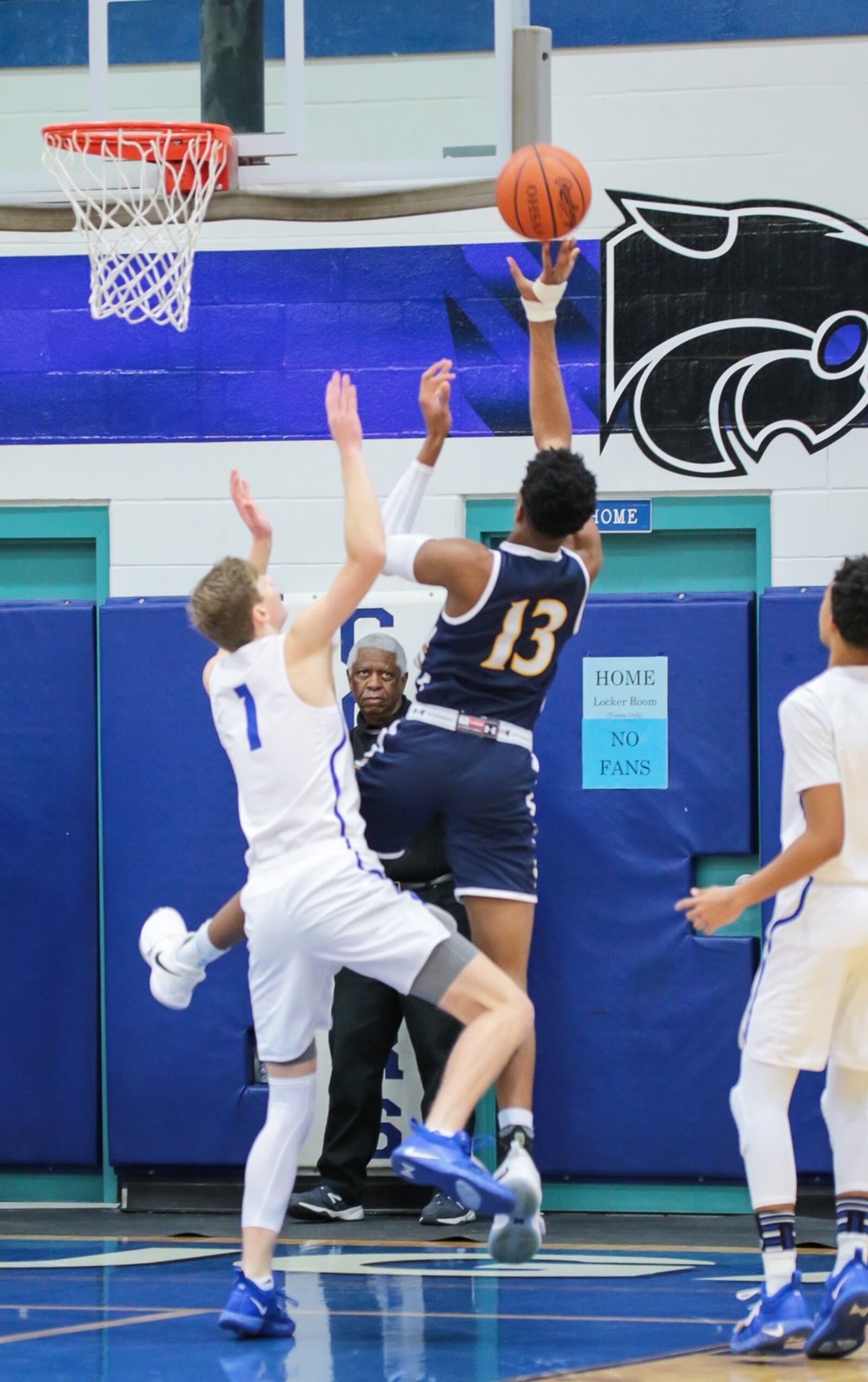 Curtis Harrison (13) of Seven Hills shoots over Cincinnati Christian’s Riley Reutener (1) during Friday night’s game at CCS. Seven Hills won 45-40. PHOTO BY KRAE/WWW.KRAEPHOTOGRAPHY.COM