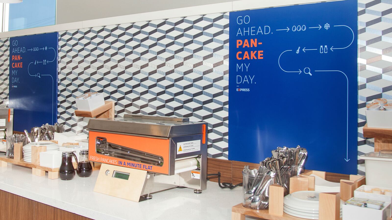 A pancake machine is picture on a breakfast bar in a Holiday Inn Express hotel.