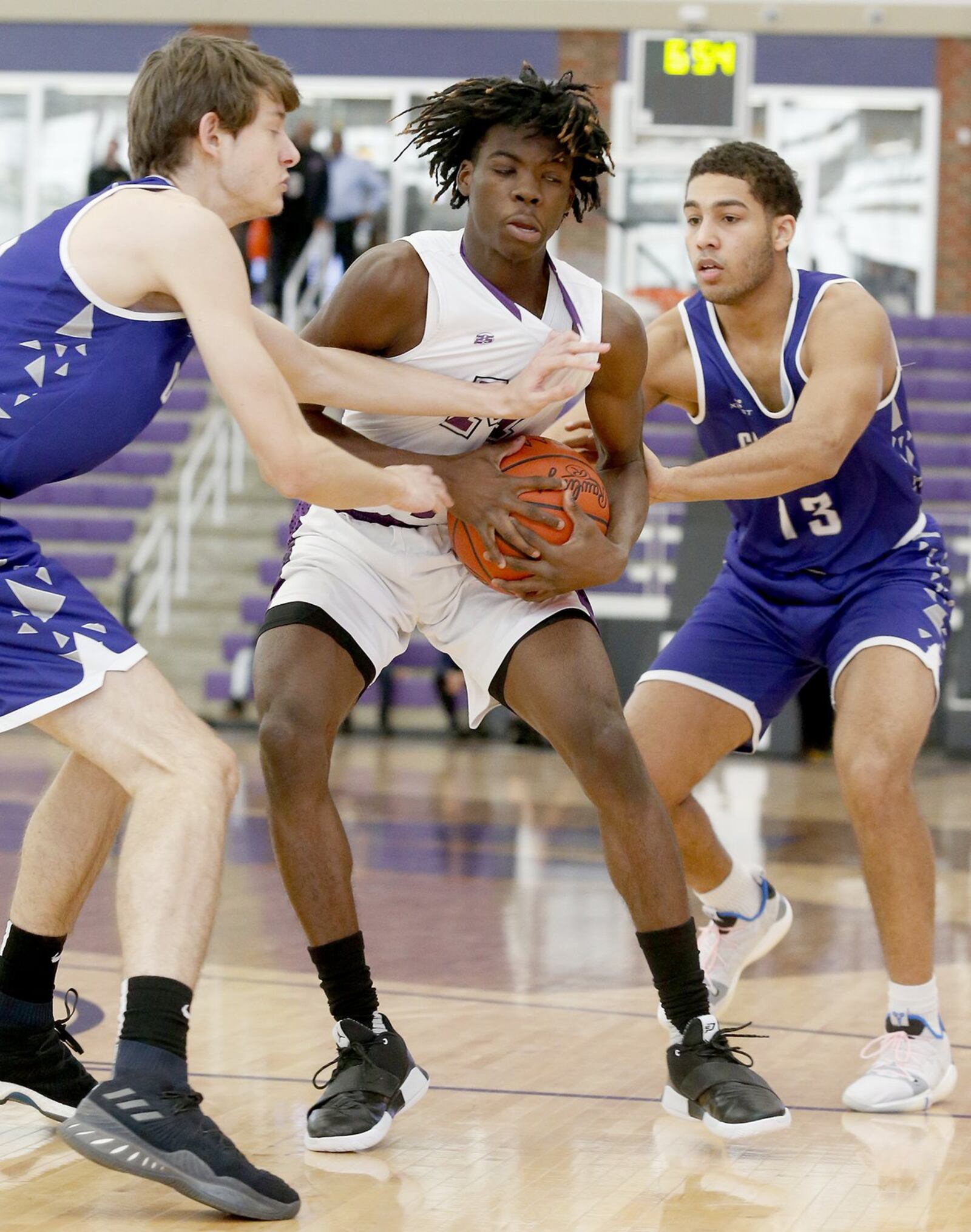 Middletown guard Jayden Jackson is double-teamed by Steven Lazar (left) and Kobe Antwi of Crestwood Prep (Canada) on Sunday during the inaugural Midwest King Classic at Wade E. Miller Arena in Middletown. Crestwood won 64-50. CONTRIBUTED PHOTO BY E.L. HUBBARD