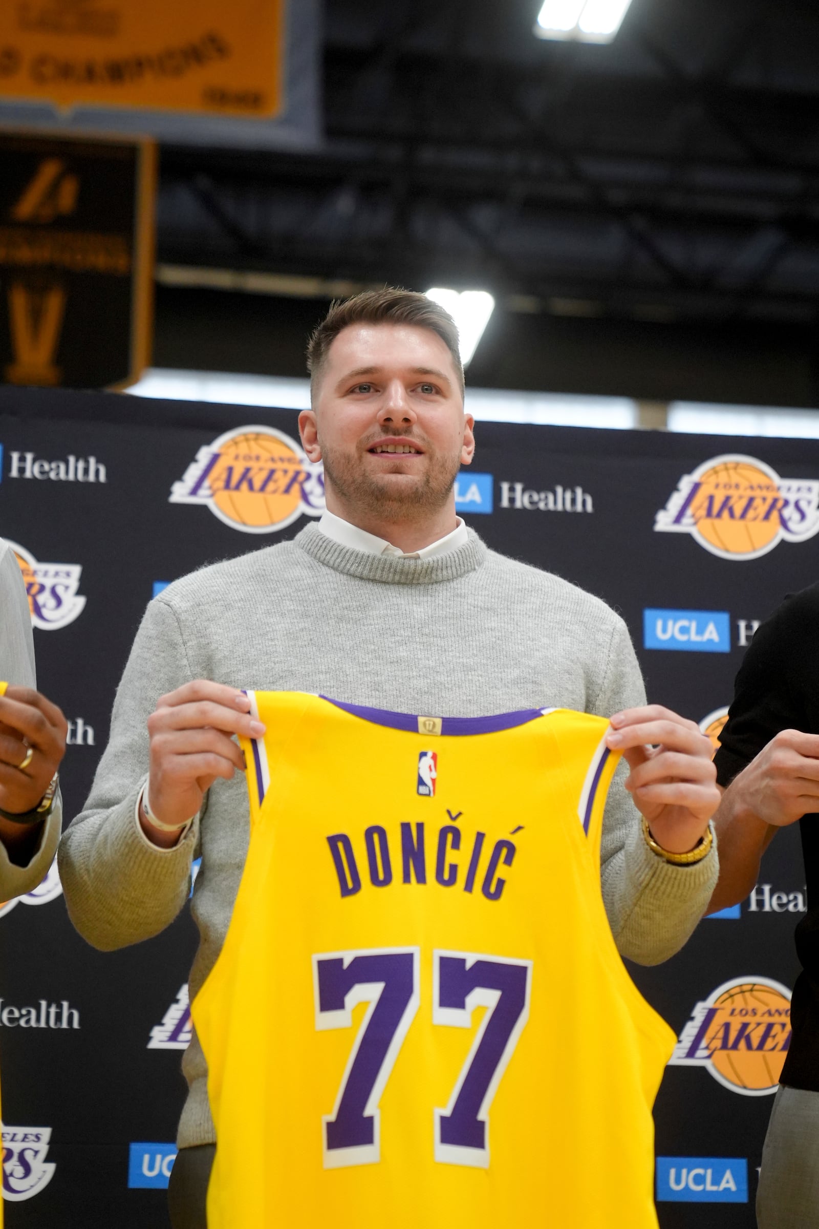 Los Angeles Lakers' Luka Doncic poses for photos with his new jersey during an introductory NBA basketball press conference Tuesday, Feb. 4, 2025, in El Segundo, Calif. (AP Photo/Jae C. Hong)