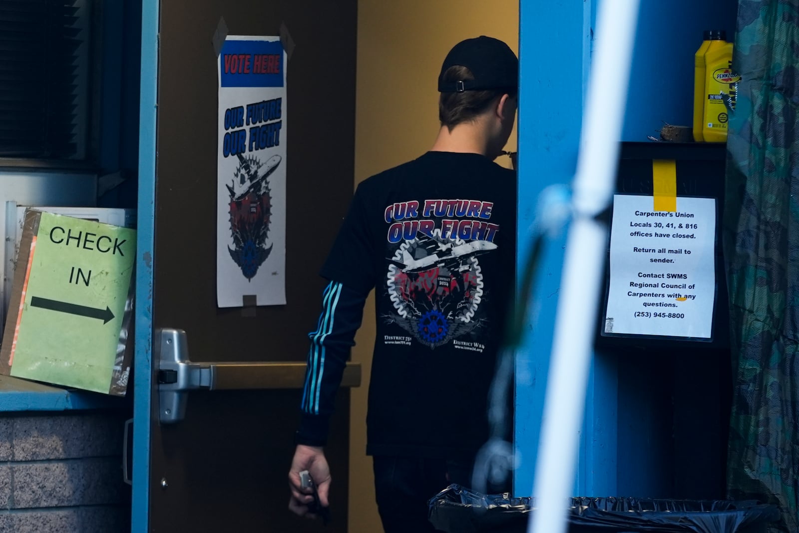 A Boeing employee, wearing a union shirt, arrives to vote on a new contract offer from the company, Monday, Nov. 4, 2024, at the Aerospace Machinists Union hall in Renton, Wash. (AP Photo/Lindsey Wasson)