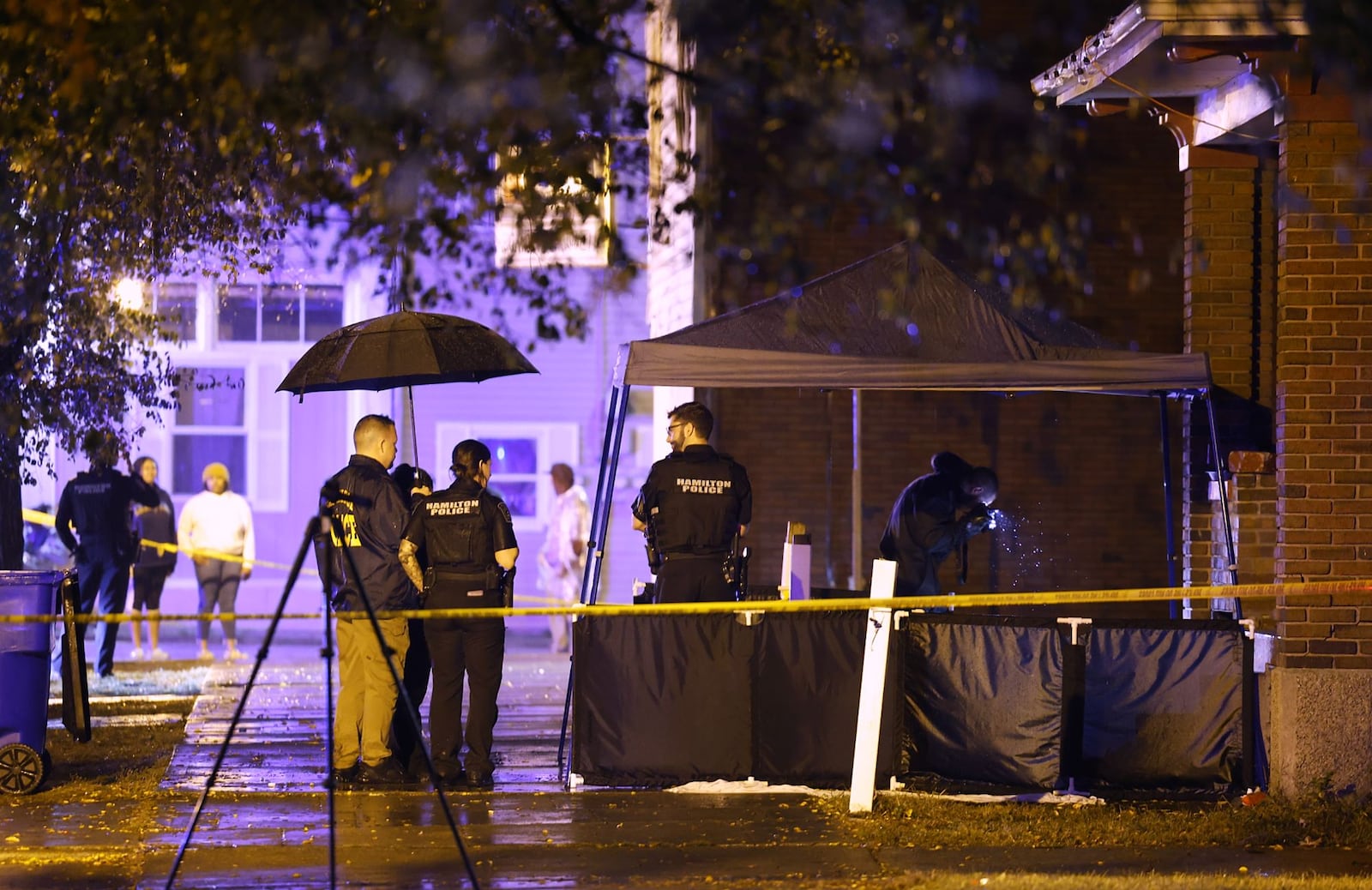 Police investigate after three people were shot Tuesday night, Oct. 25, 2022 in the 700 block of Second Street in Hamilton. Two of those shot have died and a child was also hit by bullet fragments. NICK GRAHAM/STAFF