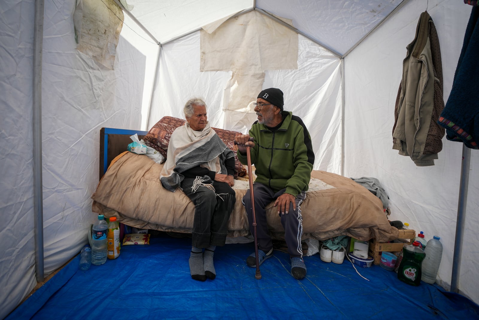 Elderly Christian married couple Amal Amouri and her husband Tony Al-Masri sit at their tent at the Muwassi tent camp near Khan Younis, Gaza Strip on Christmas Day Wednesday Dec. 25, 2024. (AP Photo/Abdel Kareem Hana)