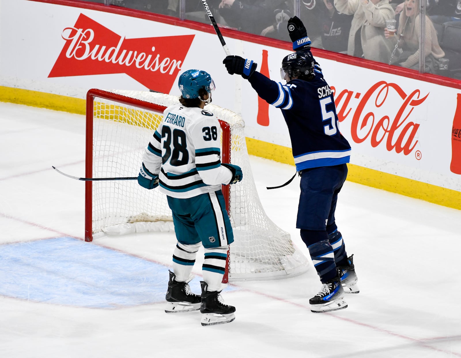 Winnipeg Jets' Mark Scheifele (55) celebrates his game-winning goal in overtime in front of San Jose Sharks' Mario Ferraro (38) during an NHL hockey game in Winnipeg, Manitoba, Monday, Feb. 24, 2025. (Fred Greenslade/The Canadian Press via AP)