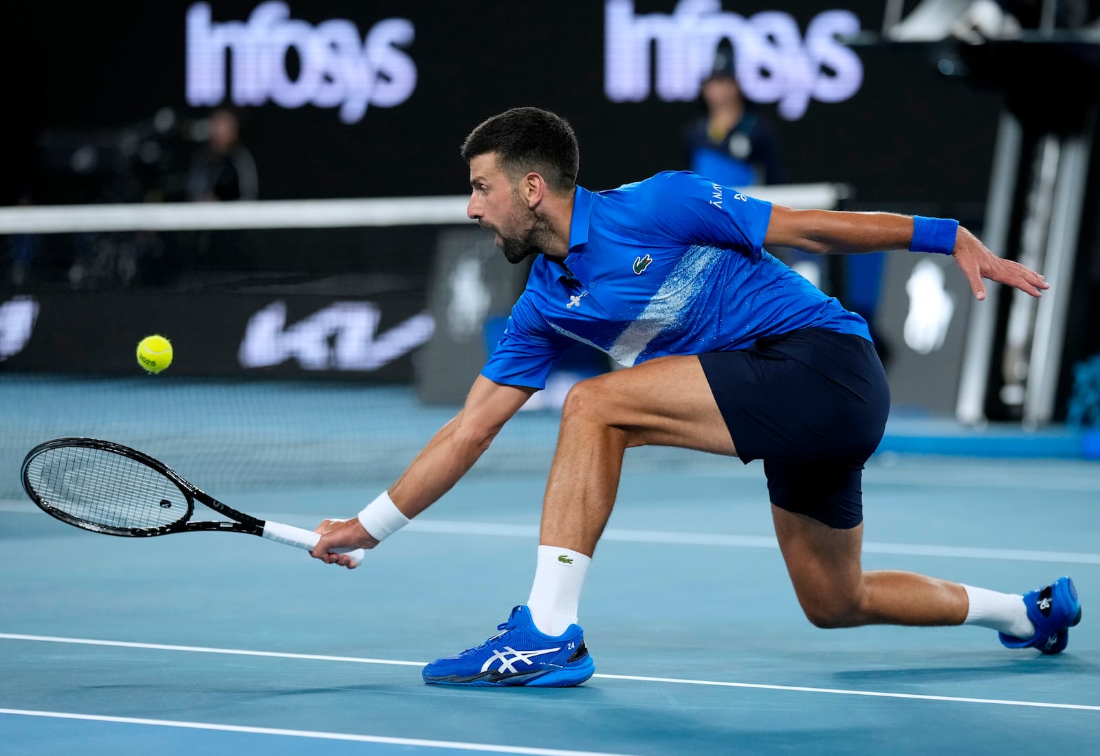 Novak Djokovic of Serbia plays a backhand return to Tomas Machac of the Czech Republic during their third round match at the Australian Open tennis championship in Melbourne, Australia, Friday, Jan. 17, 2025. (AP Photo/Asanka Brendon Ratnayake)