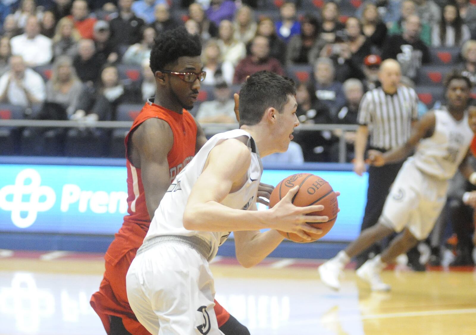 Lakota East’s Bash Wieland (with ball) is guarded by Princeton’s Aaron Ward on Saturday afternoon during a Division I district final at the University of Dayton Arena. MARC PENDLETON/STAFF