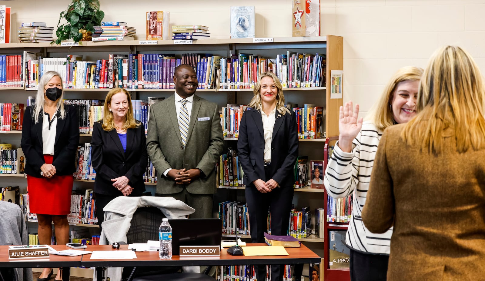 The Lakota School Board met for the first meeting with new members at Lakota Plains Junior School Monday, Jan. 10, 2022 in Liberty Township. The board members Julie Shaffer, left, Lynda O'Connor, Isaac Adi and Darbi Boddy stand as Kelley Casper is sworn in for another term. Casper was relected and Adi and Boddy are new to the board. NICK GRAHAM / STAFF