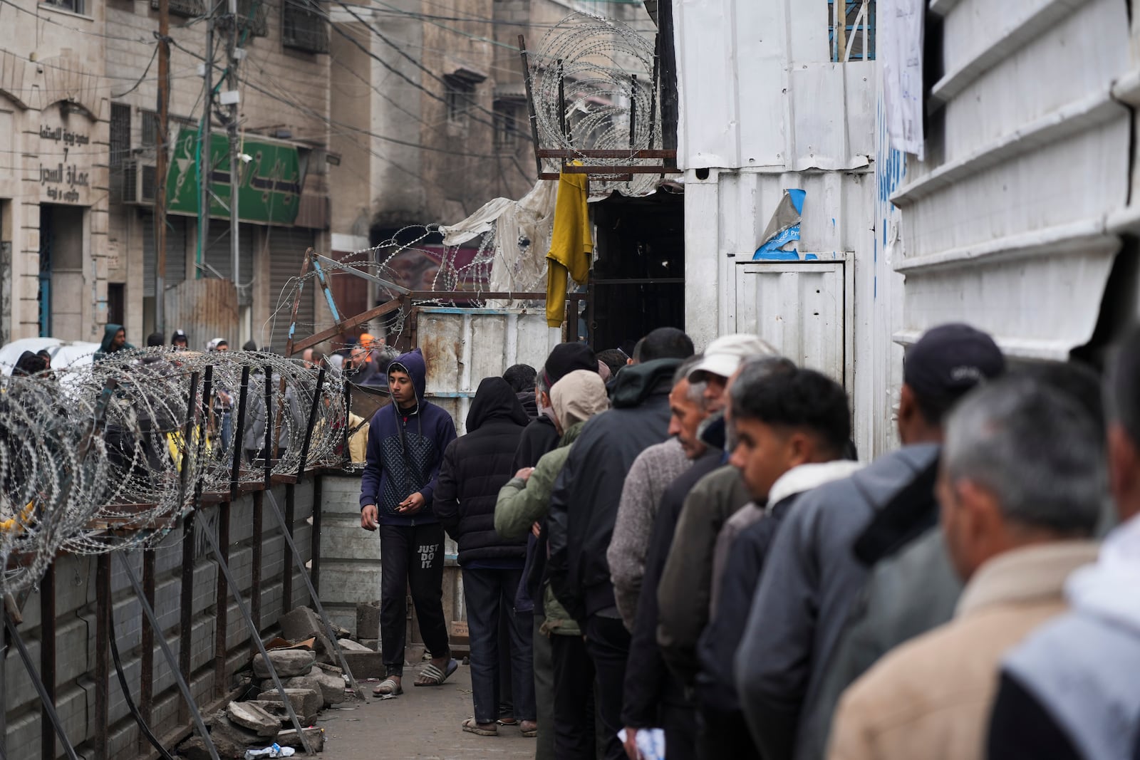 Palestinians queue to purchase bread outside a bakery in Gaza City, Monday, Feb. 24, 2025. (AP Photo/Abdel Kareem Hana)