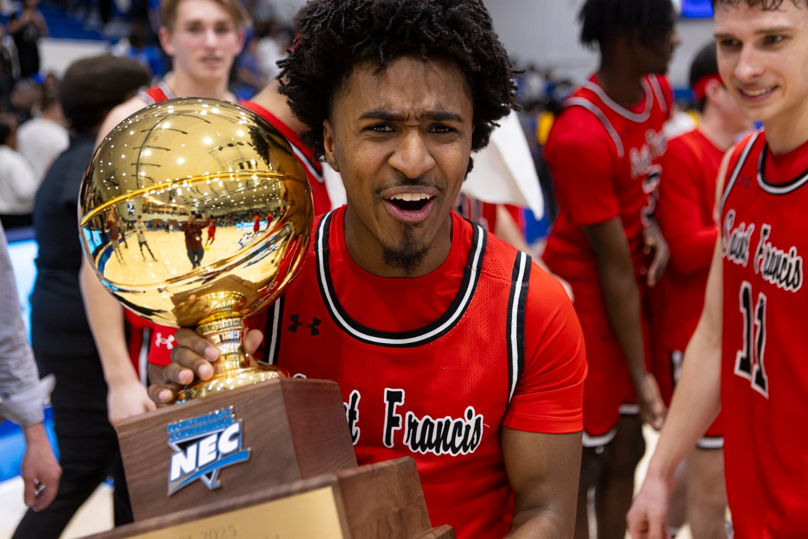 Saint Francis junior guard K.J. Swain holds the Northeast Conference tournament trophy. CONTRIBUTED