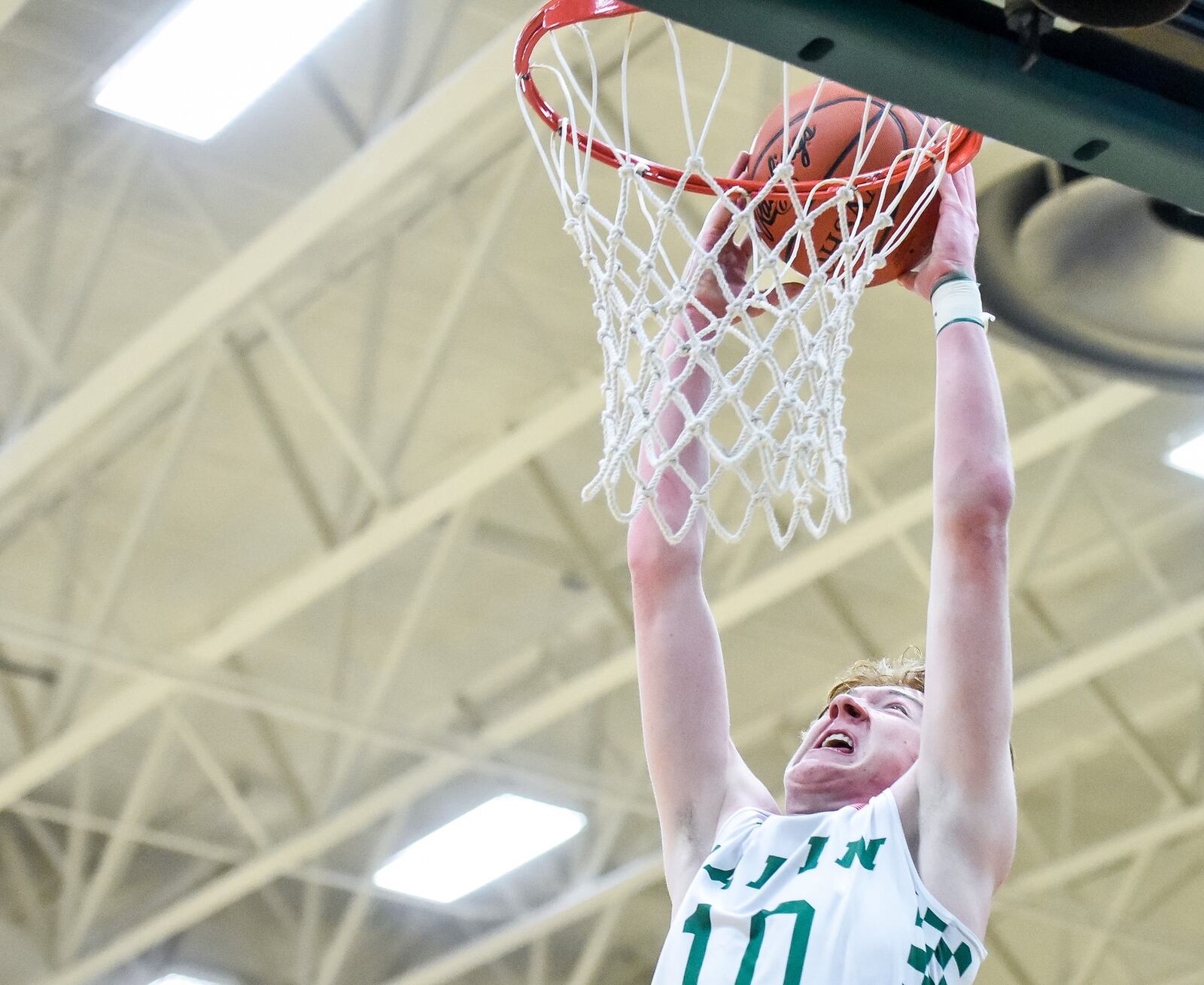 Badin’s Zach Switzer goes up for a slam dunk during Friday night’s game against Purcell Marian at Mulcahey Gym in Hamilton. Purcell won 64-52. NICK GRAHAM/STAFF