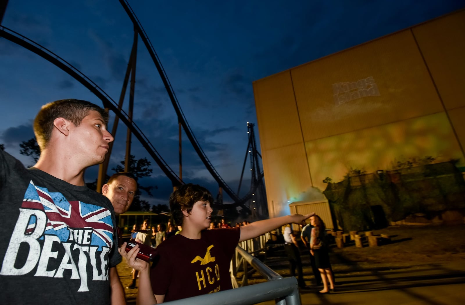 Chris Kalejs and Micah Kalejs, 11, wait for the announcement of what turned out to be the Mystic Timbers wooden roller coaster Thursday night, July 29 at Kings Island Amusement Park in Mason. Hundreds gathered for the announcement that happened just after 10 p.m. NICK GRAHAM/STAFF