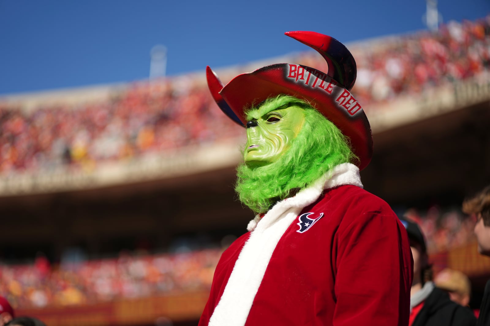 A fan dressed as The Grinch is seen during the first half of an NFL football game between the Kansas City Chiefs and the Houston Texans Saturday, Dec. 21, 2024, in Kansas City, Mo. (AP Photo/Charlie Riedel)