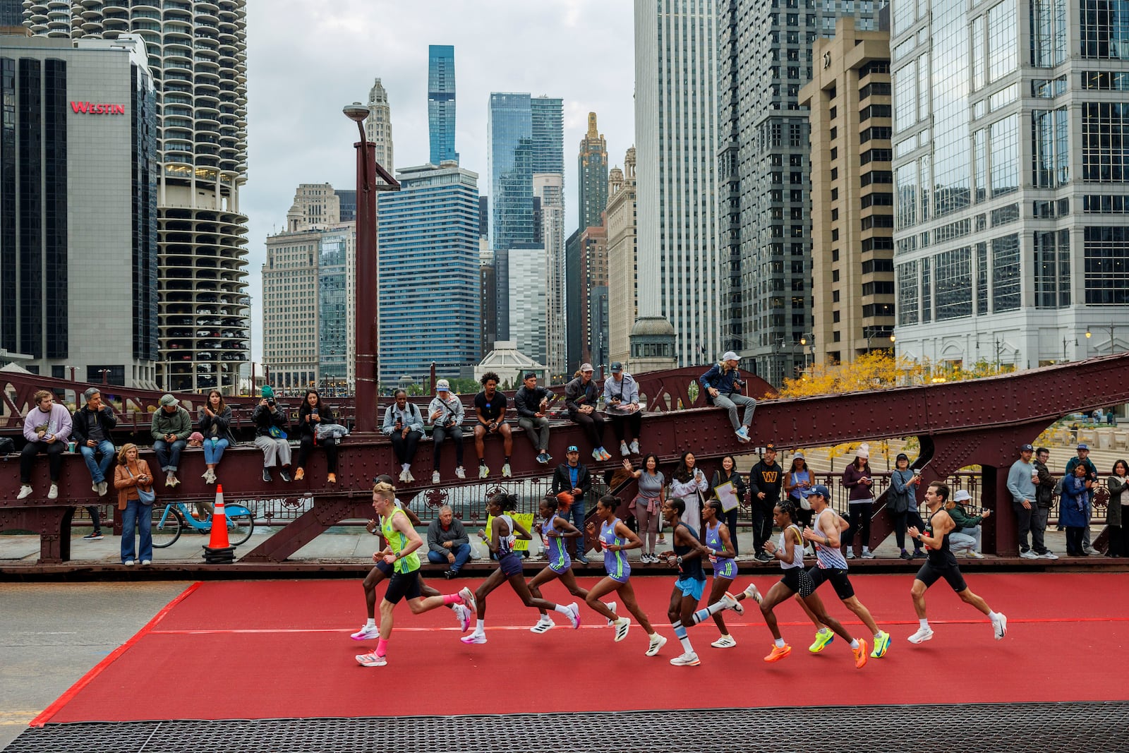 Runners cross the LaSalle Street bridge during the Chicago Marathon Sunday Oct. 13, 2024, in Chicago. (Armando L. Sanchez//Chicago Tribune via AP)