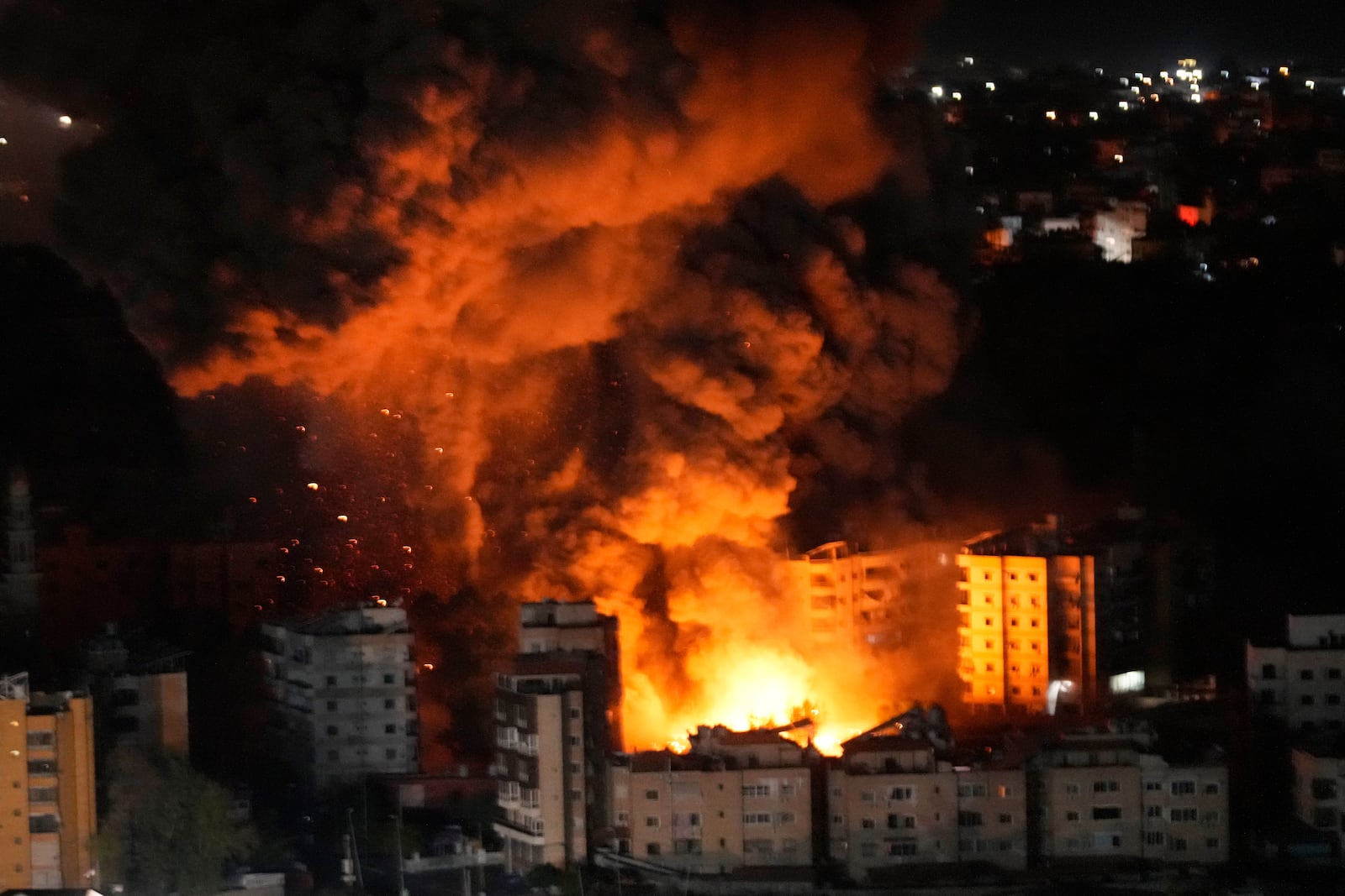 Flame and smoke rises from buildings hit by Israeli airstrikes on Dahiyeh, in the southern suburb of Beirut, Wednesday, Oct. 23, 2024. (AP Photo/Hussein Malla)