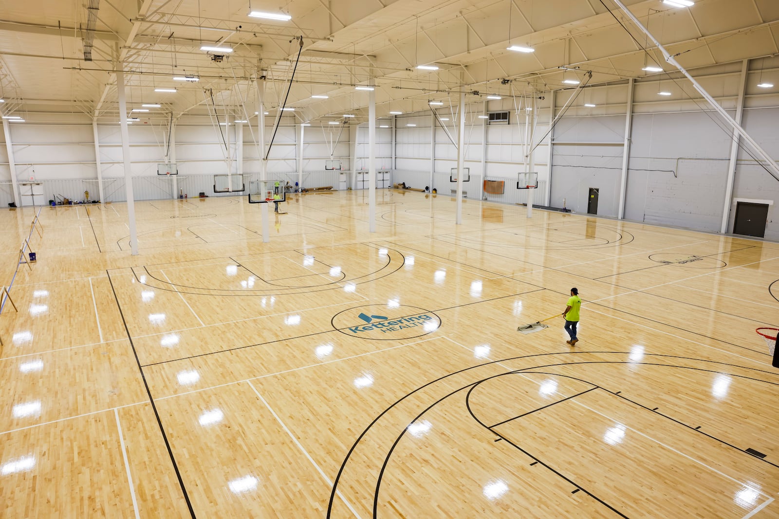 In this file photo, crews put finishing touches on the hardwood and other courts at Spooky Nook sports Champion Mill. There are 14 hardwood basketball courts and 14 sports courts for a total of 28 basketball courts that can be converted to volleyball courts and other types of courts like pickleball, futsal or field hockey. Basketball and volleyball teams are already practicing at the facility. NICK GRAHAM/FILE