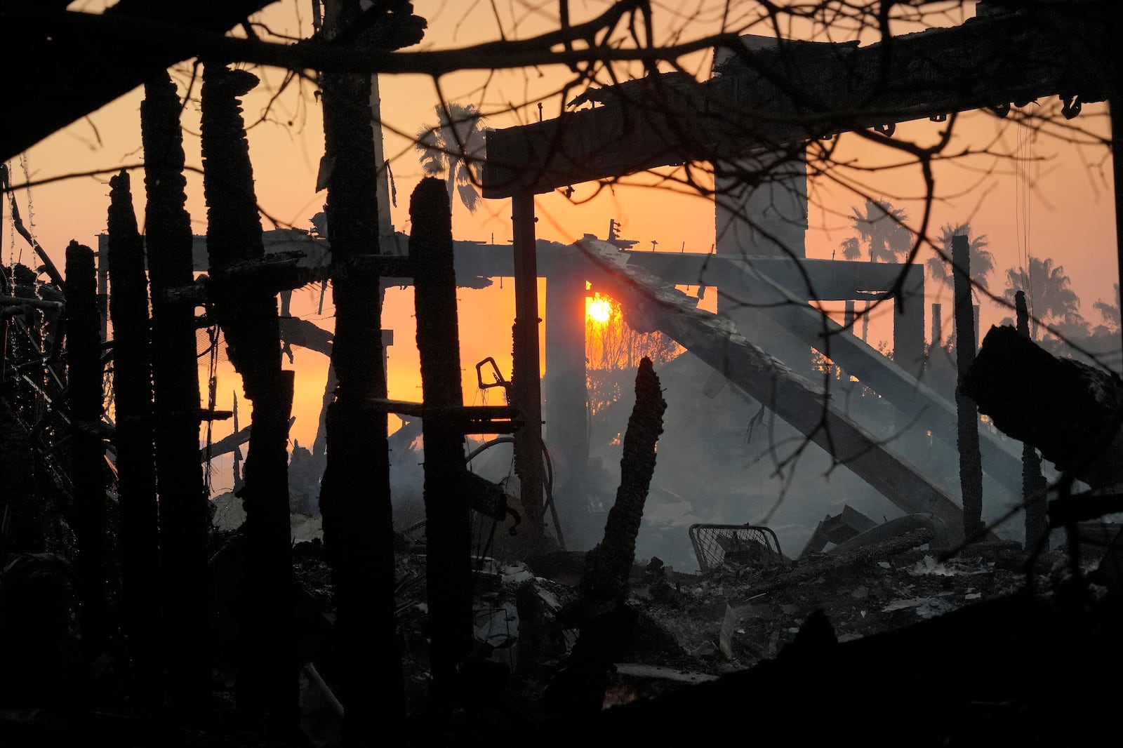 The sun rises after the Palisades Fire ravaged a neighborhood in the Pacific Palisades neighborhood of Los Angeles, Thursday, Jan. 9, 2025. (AP Photo/Damian Dovarganes)