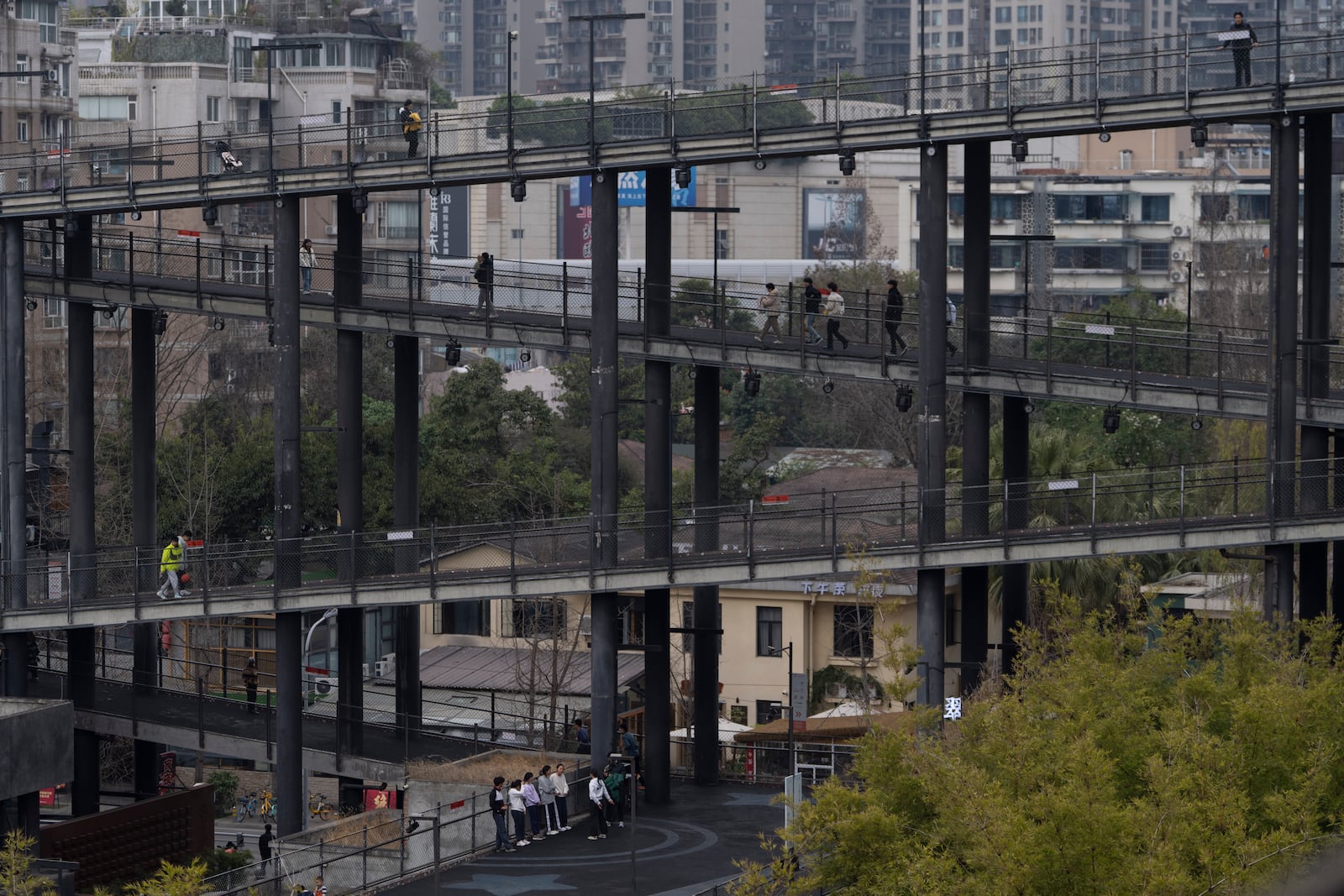 Visitors walk on the walk way at the West Village project by Pritzker Architecture Prize winner Chinese architect Liu Jiakun in Chengdu in southwestern China's Sichuan province on Sunday, March 2, 2025. (AP Photo/Ng Han Guan)