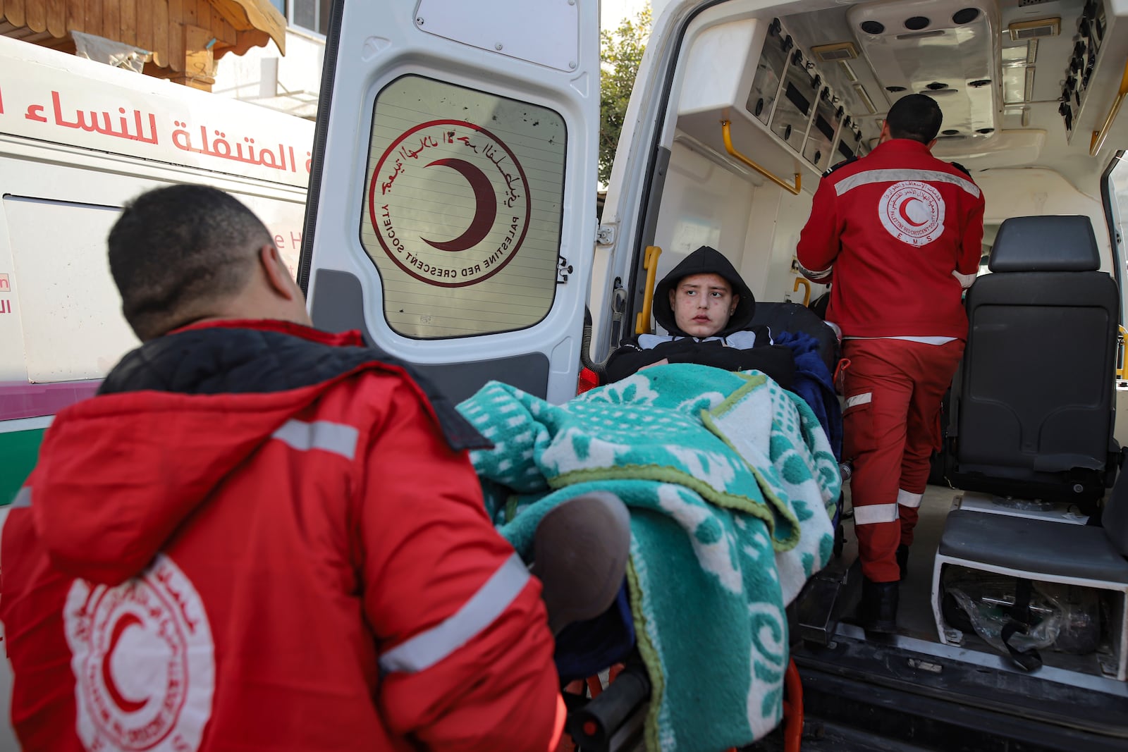 A Palestinian girl wounded in the Israeli bombardment of the Gaza Strip is carried by medics before crossing the Rafah border into Egypt, as wounded and sick Palestinians are allowed to leave the Gaza Strip for medical treatment, in Khan Younis, Saturday Feb. 1, 2025. (AP Photo/Jehad Alshrafi)