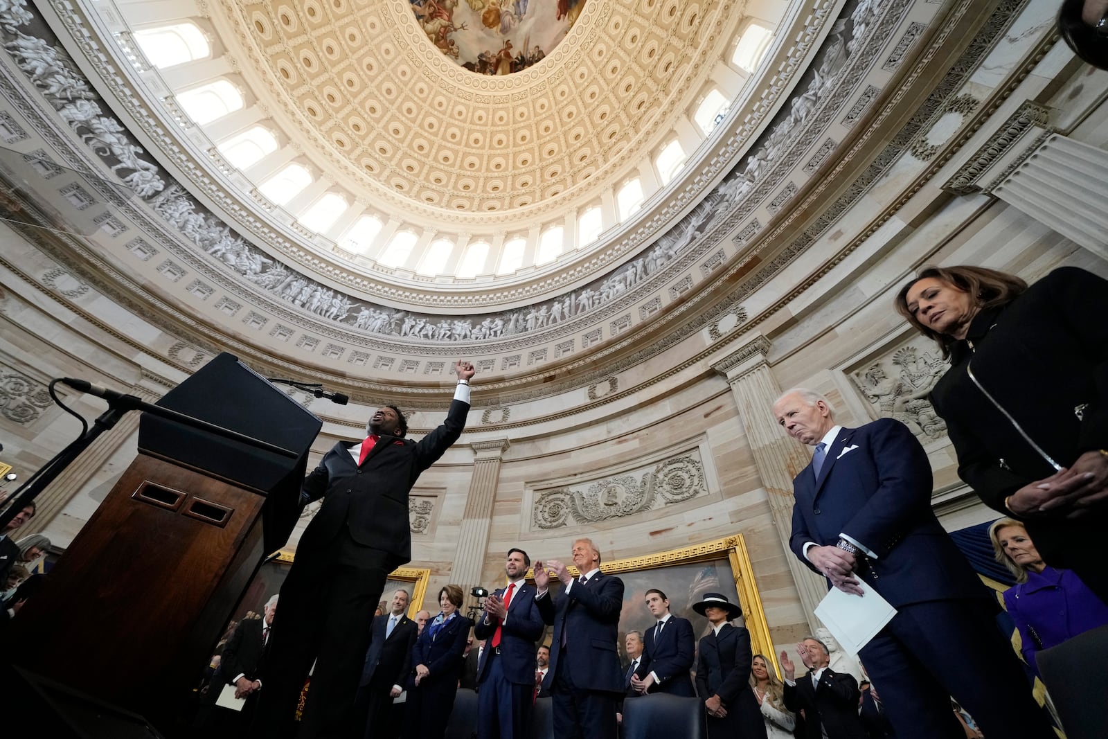 Senior Pastor Lorenzo Sewell, left, gestures during the Benediction as from l-r., Vice President JD Vance, President Donald Trump, former President Joe Biden, and former Vice-President Kamala Harris look on during the 60th Presidential Inauguration in the Rotunda of the U.S. Capitol in Washington, Monday, Jan. 20, 2025. (AP Photo/Morry Gash, Pool)