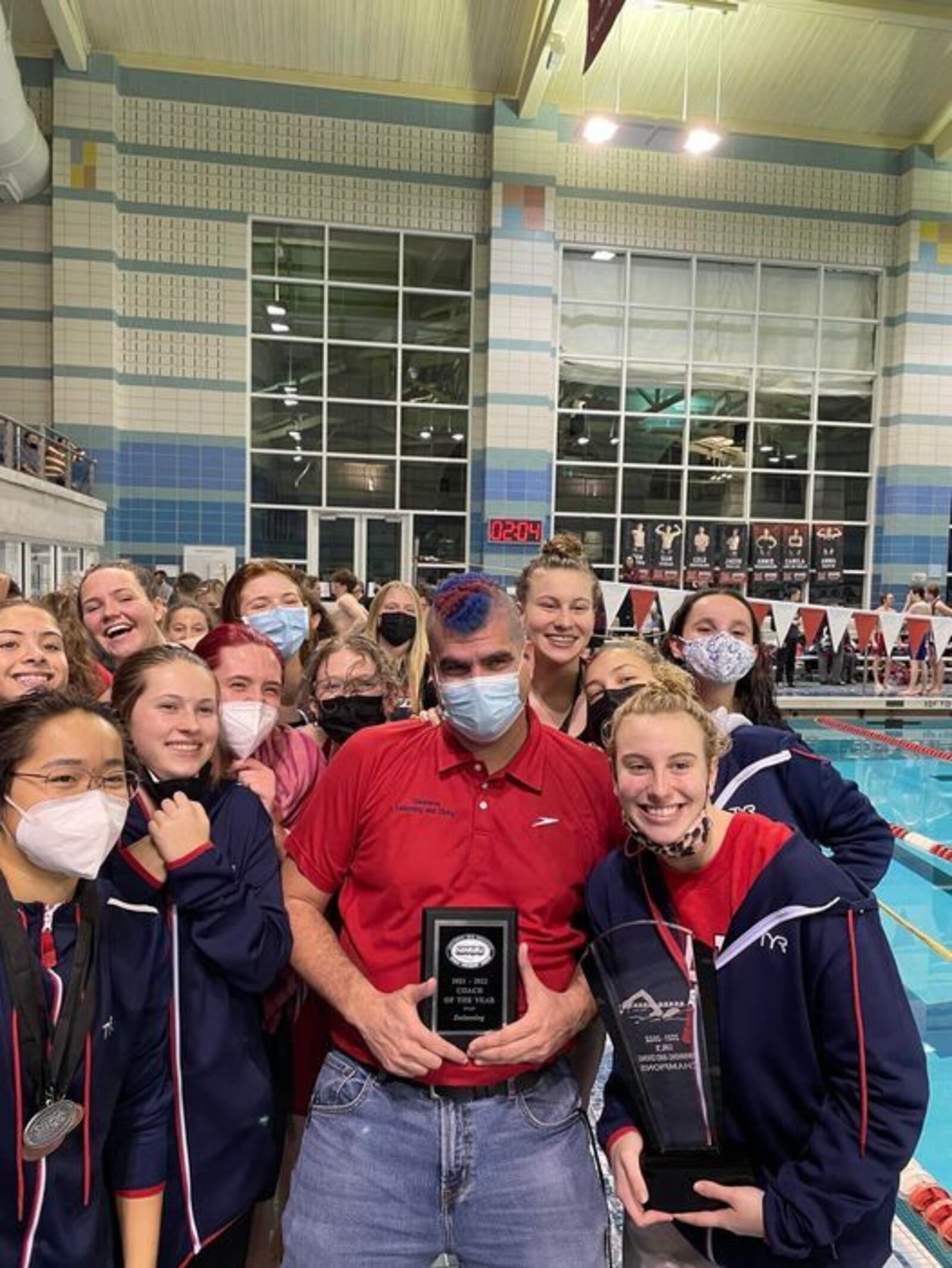 Talawanda girls’ swimming and diving team celebrates their league championship at Miami last weekend. Coach Steve Pasquale, who inspired his teams with an unusual hair style with school colors red and blue, is shown in front. He was named Coach of the Year because of the success of his team coming back from a second-place finish a year ago. CONTRIBUTED