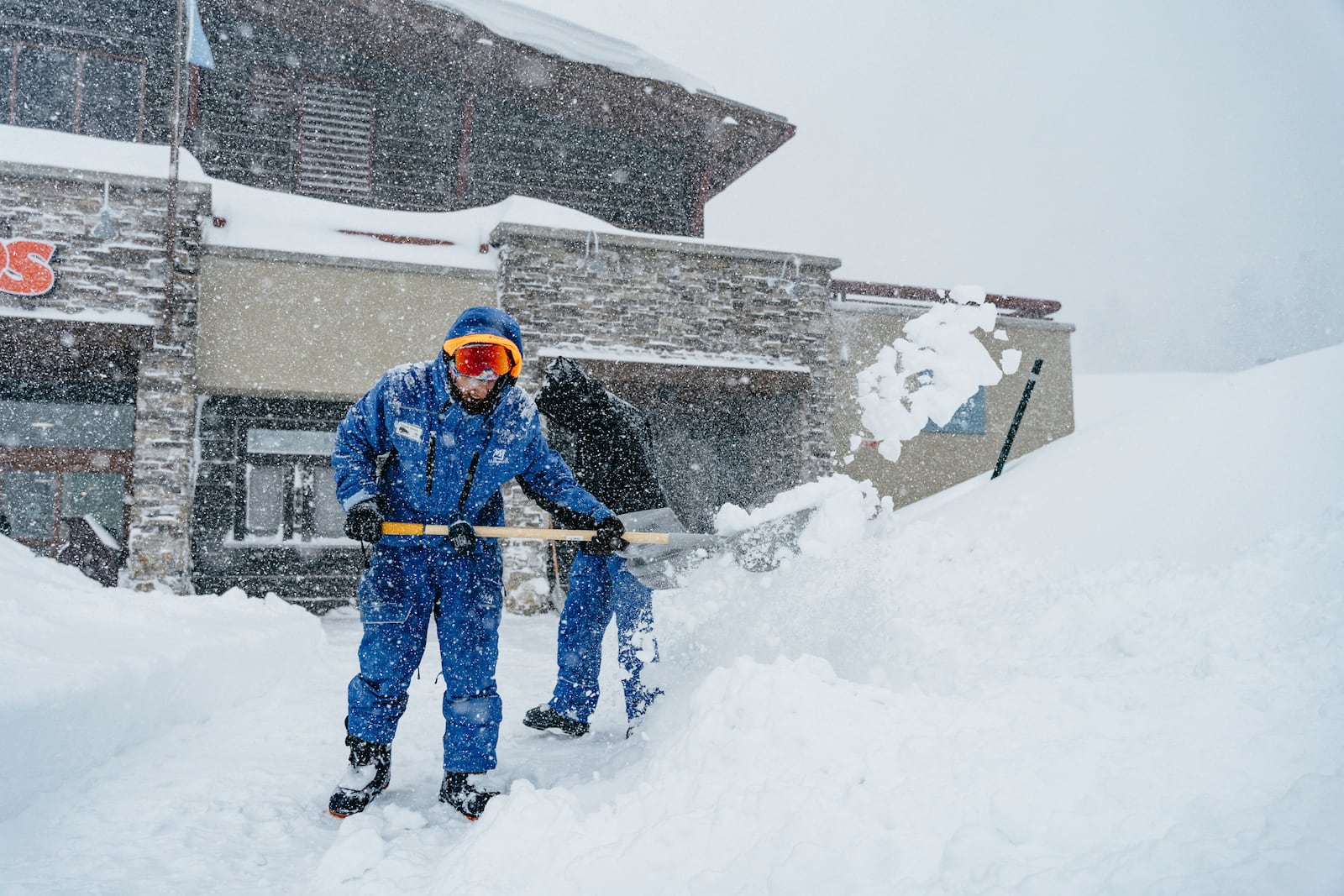 Workers shovel snow during a storm at the Mammoth Mountain Ski Area Thursday, Feb. 13, 2025, in Mammoth Lakes, Calif. (Cody Mathison/Mammoth Mountain via AP)