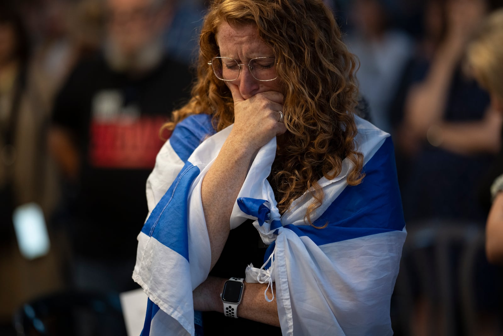 FILE - A woman closes her eyes during a vigil in memory of slain hostage Hersh Goldberg-Polin in Jerusalem, Israel, Sunday, Sept. 1, 2024. (AP Photo/Leo Correa, File)