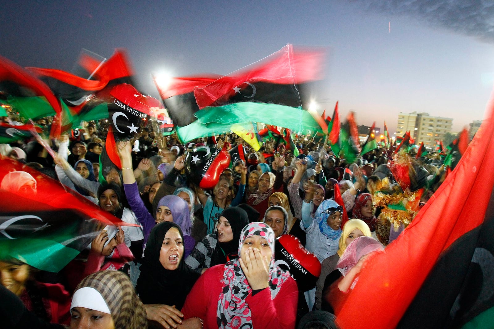 FILE - Libyans celebrate the official liberation of Libya after months of bloodshed that culminated in the death of longtime leader Moammar Gadhafi, at Saha Kish Square in Benghazi, Libya, on Oct. 23, 2011. (AP Photo/Francois Mori, File)