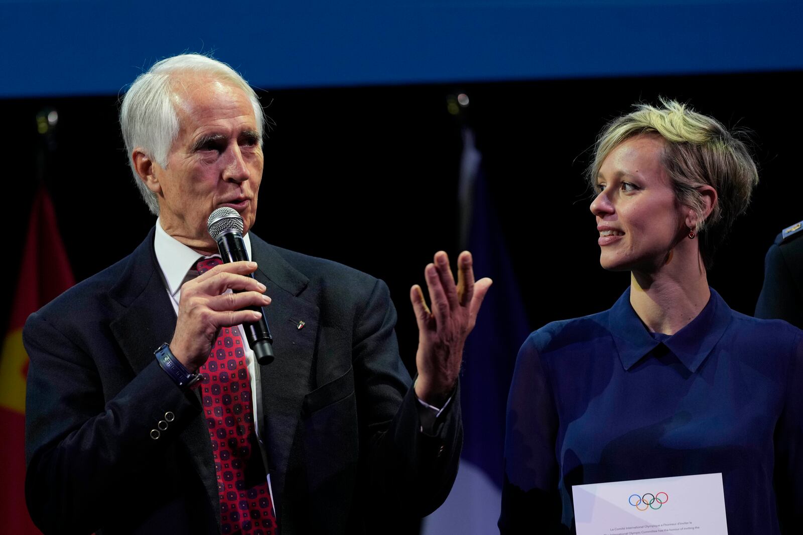 Italian National Olympic Committee president Giovanni Malago, with Federica Pellegrini, speaks during the ceremony 'One Year To Go' for the 2026 Milano-Cortina Winter Olympics, at the Strehler Theatre, in Milan, Italy, Thursday, Feb. 6, 2025. (AP Photo/Luca Bruno)