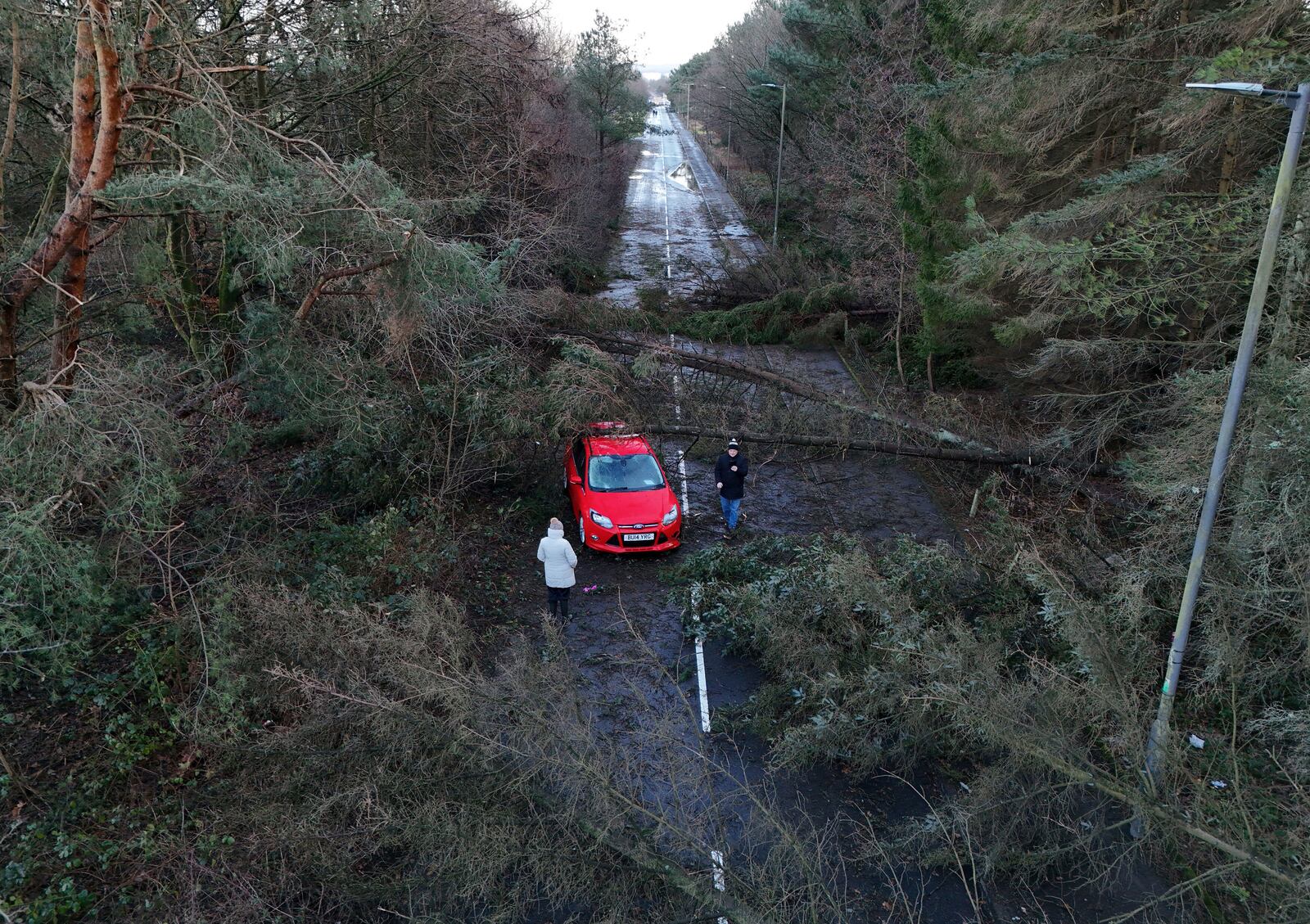 A car abandoned in Tryst Road in Larbert surrounded by fallen trees after Storm Eowyn, in Larbert, Scotland, Saturday, Jan. 25, 2025. (Andrew Milligan/PA via AP)