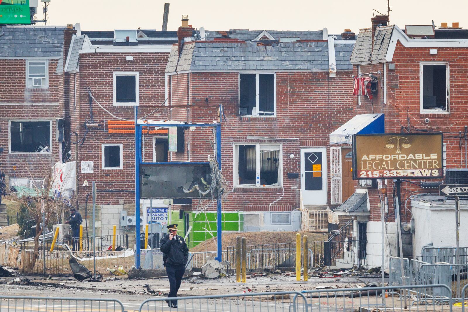 Police walk through the scene of a medical jet crash Monday morning Feb. 3, 2025, in Philadelphia. (Alejandro A. Alvarez/The Philadelphia Inquirer via AP)