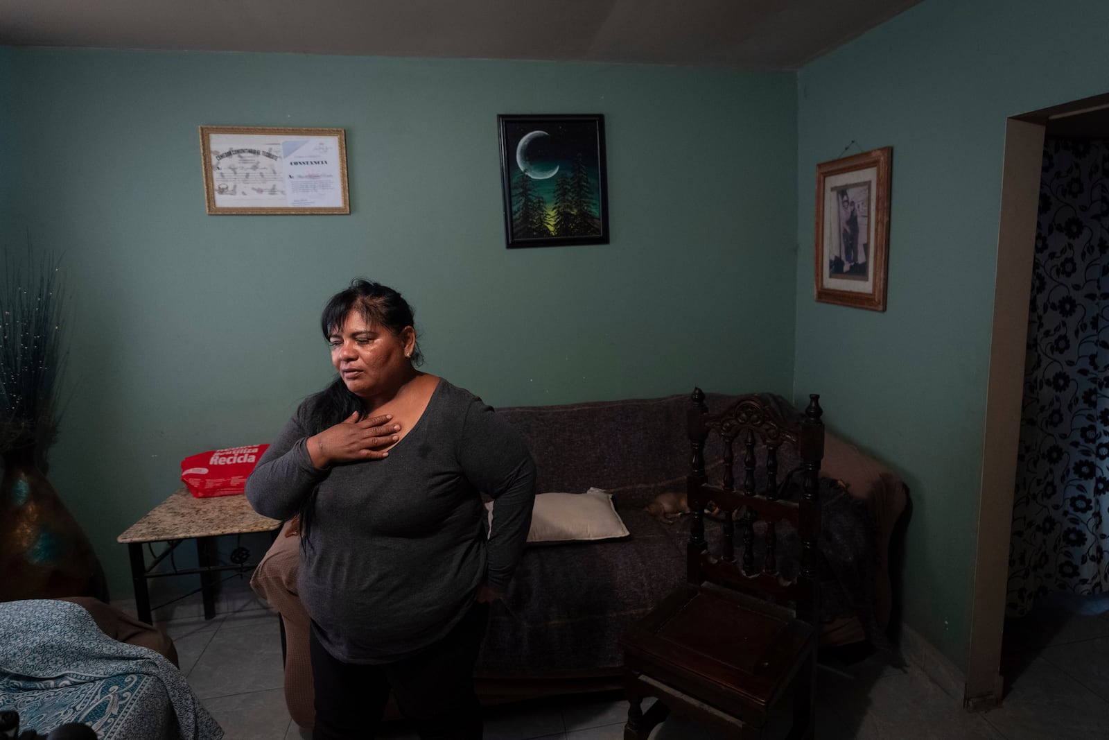 Martha Rosales takes a moment as she talks about the Cuban migrants she has housed as they wait for an appointment to apply for asylum in the United States through the CBP One app Wednesday, May 22, 2024, in Tijuana, Mexico. (AP Photo/Gregory Bull)