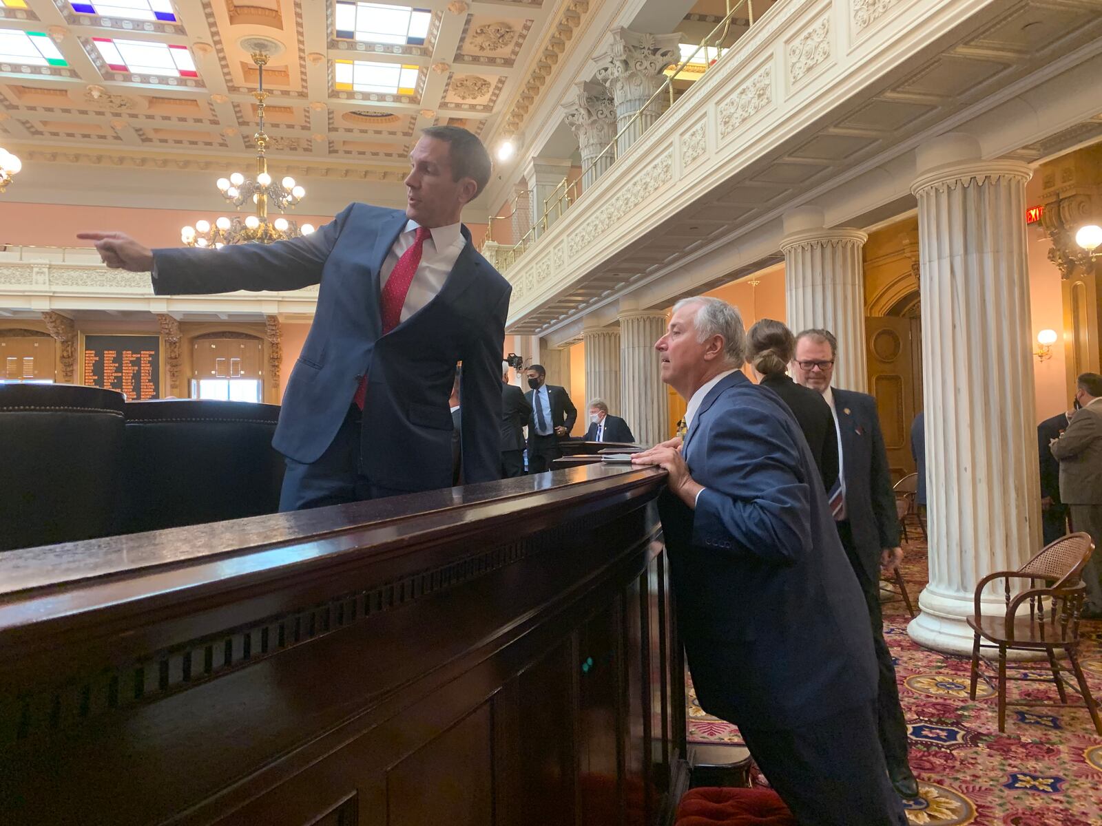 State Rep. Jim Butler, R-Oakwood, directs former Ohio House speaker Larry Householder, R-Glenford, to his new seating assignment.  Under indictment in a public corruption case, Householder attended session.