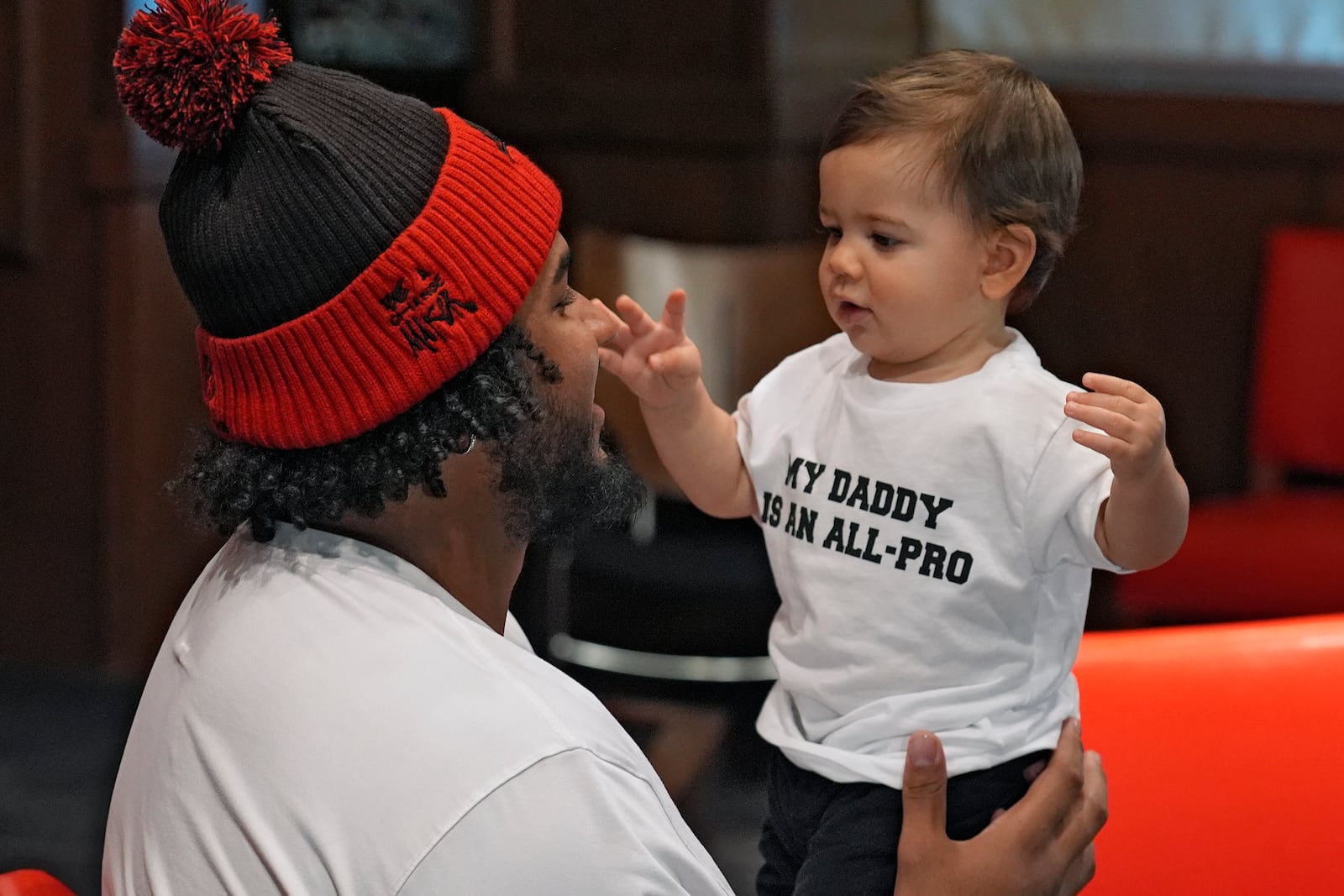 Tampa Bay Buccaneers offensive lineman Tristan Wirfs holds his son Julius during an NFL football news conference Thursday, Jan. 9, 2025, in Tampa, Fla. Wirfs has been named to the AP All-Pro football team. (AP Photo/Chris O'Meara)