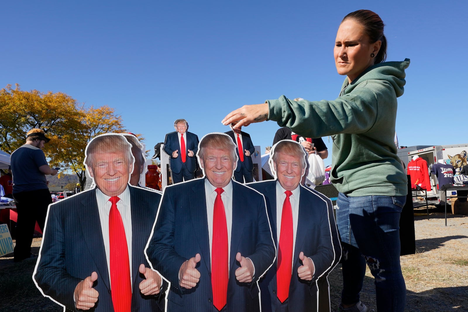 Whitney Bruce of Roanoke, Va., looks at items for sale before Republican presidential nominee former President Donald Trump speaks at a campaign rally in Salem Va., Saturday, Nov 2, 2024. (AP Photo/Steve Helber)