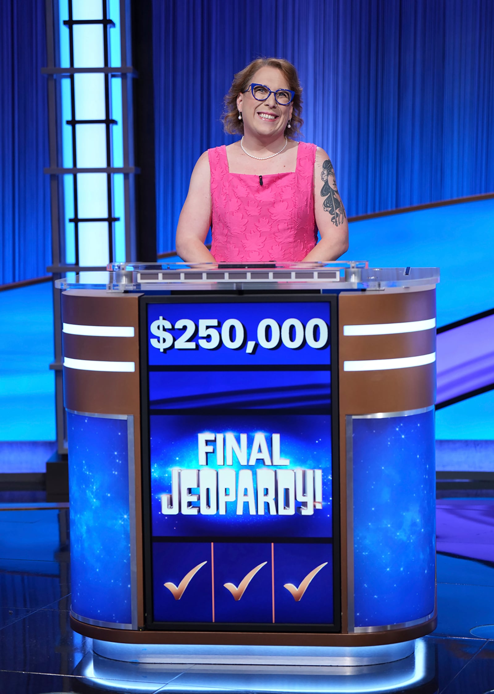 In this undated photo provided by Jeopardy Productions, Inc., "Jeopardy!" contestant Amy Schneider poses for a picture. Schneider capped her big year by winning a hard-fought “Jeopardy!” tournament of champions in an episode that aired Monday, Nov. 21, 2022. (Tyler Golden/Sony Pictures Television/Courtesy of Jeopardy Productions, Inc. via AP)