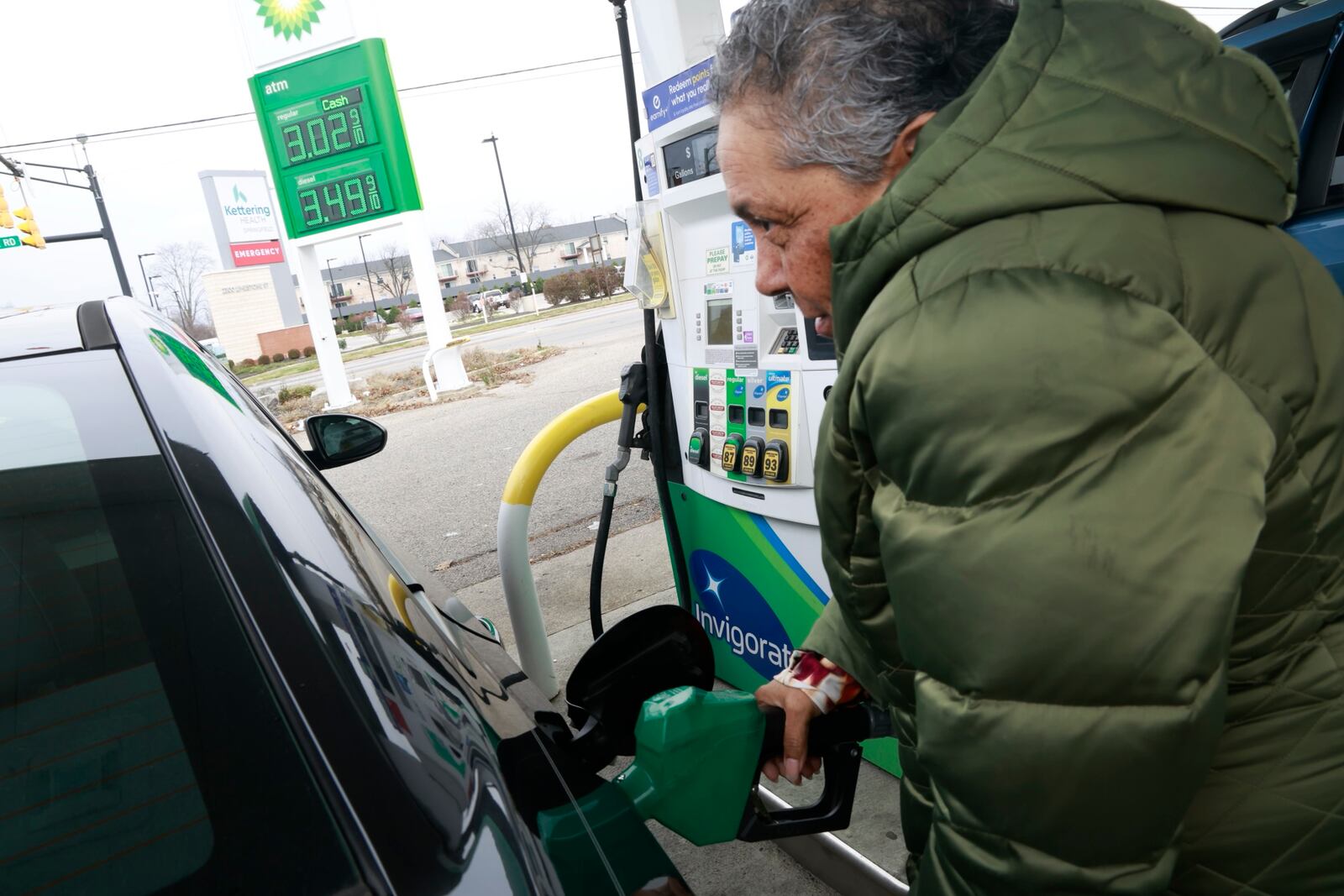 Lora Ragland pumps gas at the BP gas station at the intersection of North Limestone Street and Home Road Wednesday, Dec. 4, 2024. BILL LACKEY/STAFF