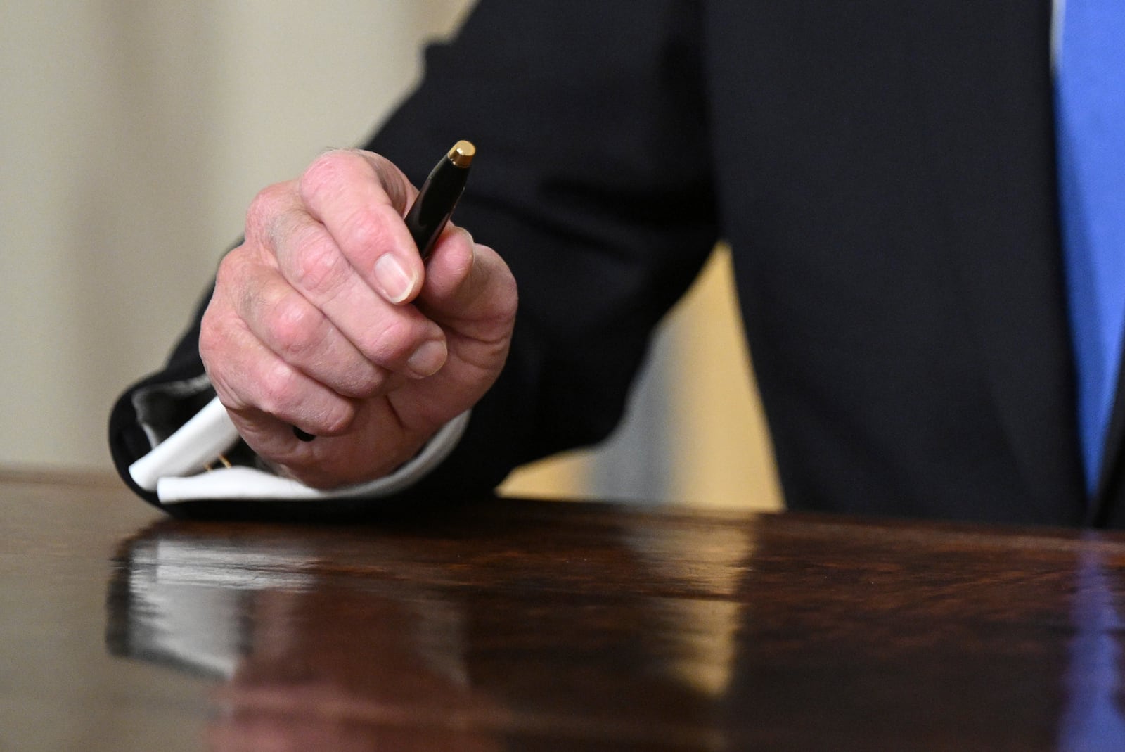 President Joe Biden holds a pen as he speaks from the Oval Office of the White House as he gives his farewell address Wednesday, Jan. 15, 2025, in Washington. (Mandel Ngan/Pool via AP)