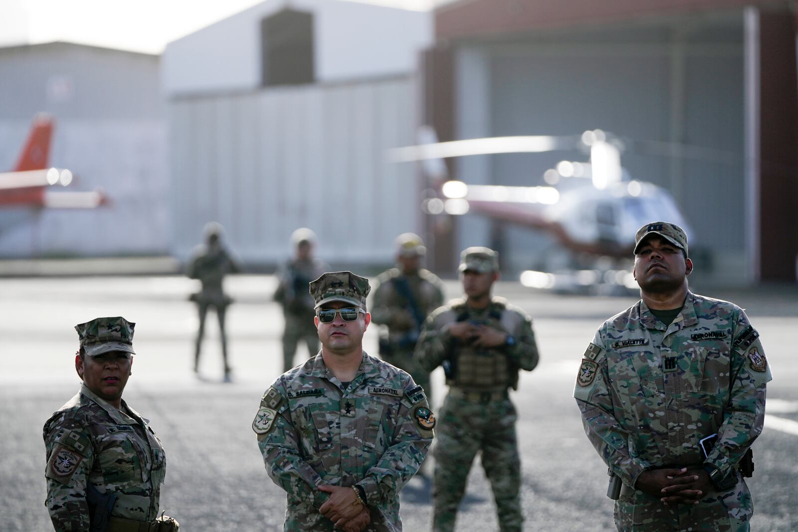 Security officers stand on the tarmac before Secretary of State Marco Rubio arrives to watch people board a repatriation flight bound for Colombia at Albrook Airport in Panama City, Monday, Feb. 3, 2025. (AP Photo/Mark Schiefelbein, Pool)