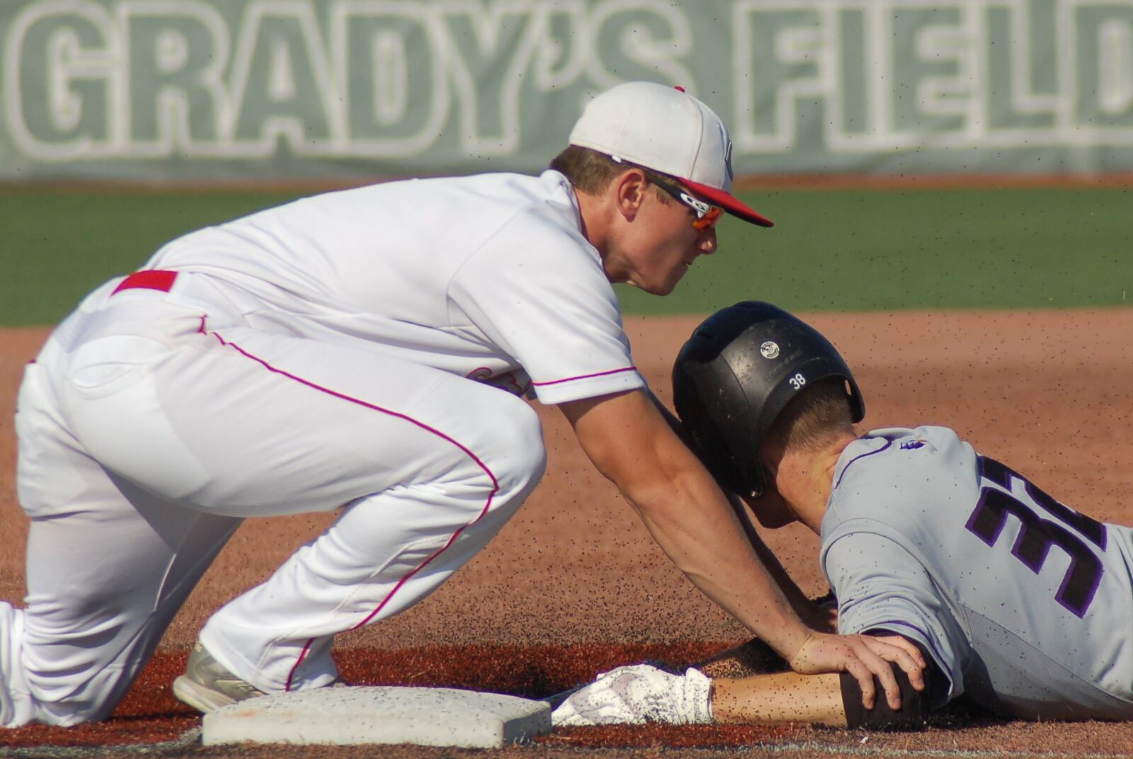 Carlisle’s Caleb Boy gets the out on Cincinnati Hills Christian Academy’s Grayson Hodges on Friday in a Division III regional final. Hodges tried to stretch a double into a triple on the play at the Athletes in Action complex in Xenia. CONTRIBUTED PHOTO BY JOHN CUMMINGS