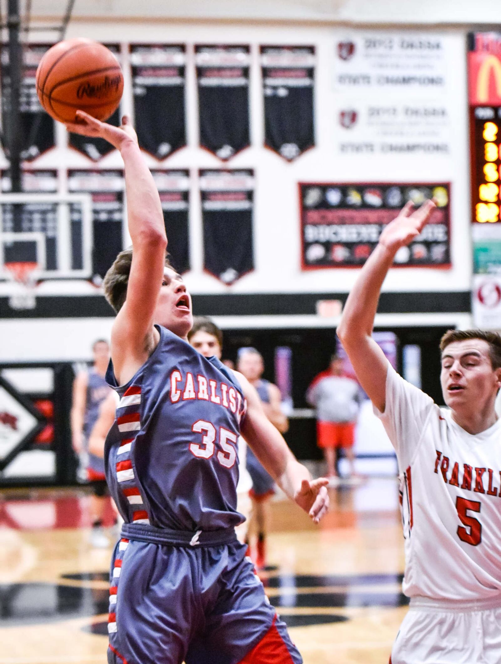 Carlisle's Johnathan Shepherd puts up a shot as Franklin’s Cole Bundren defends Tuesday night at Darrell Hedric Gym in Franklin. NICK GRAHAM/STAFF