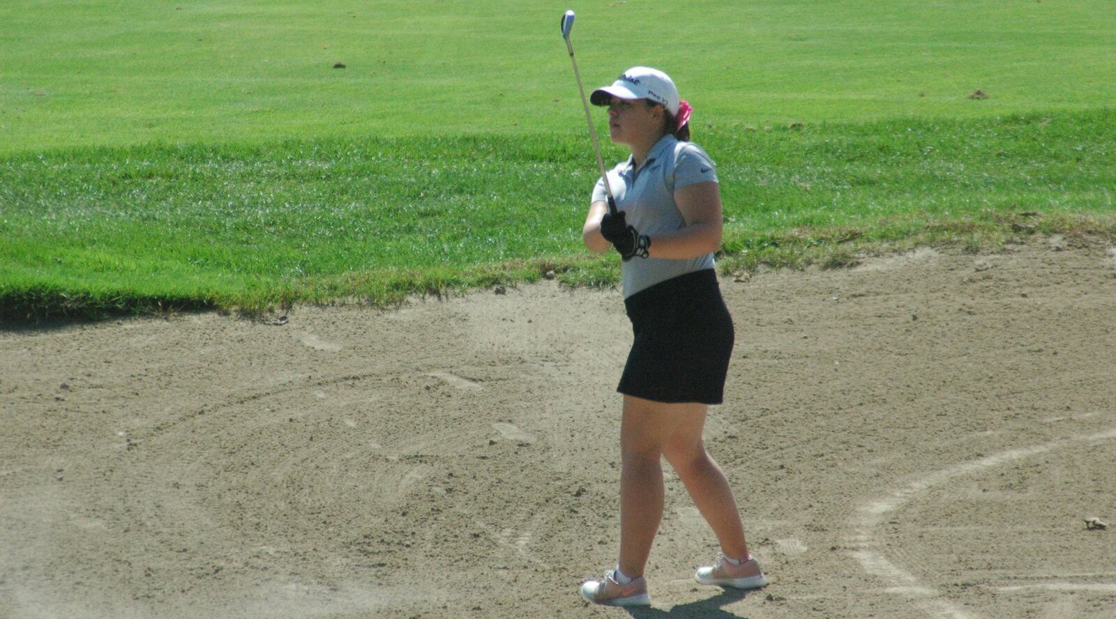 Lakota East’s Samantha Bernardo watches her shot as she hits out of a sand trap on the 18th hole of the Division I sectional girls golf tournament Monday at Walden Ponds Golf Club in Fairfield Township. RICK CASSANO/STAFF