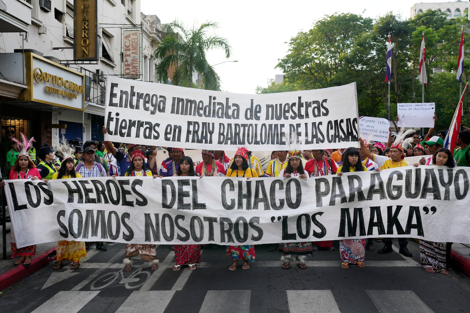 FILE - Maka Indigenous people march to demand the recovery of ancestral lands in Asuncion, Paraguay, Feb. 28, 2024. The signs read in Spanish: "Immediate turnover of our lands in Fray Bartolome de las Casas," top, and "The heroes of Paraguayan Chaco are us, the Maka." (AP Photo/Jorge Saenz, File)