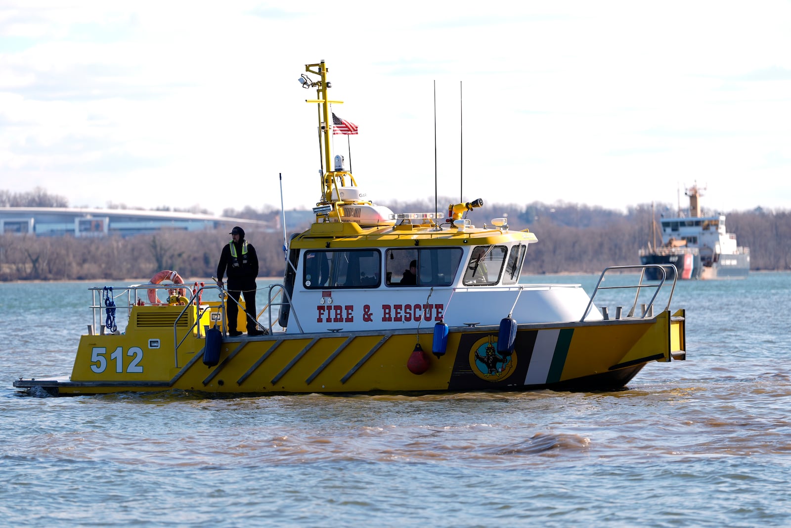 Members of a Fire and Rescue team search for debris on the Potomac river, Saturday, Feb. 1, 2025, in Alexandria, Va., near the wreckage site where an American Airlines jet and a Black Hawk helicopter collided. (AP Photo/Carolyn Kaster)