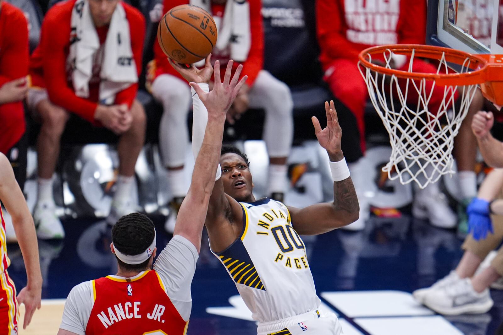 Indiana Pacers guard Bennedict Mathurin (00) shoots over Atlanta Hawks forward Larry Nance Jr. (22) during the second half of an NBA basketball game in Indianapolis, Saturday, Feb. 1, 2025. (AP Photo/Michael Conroy)