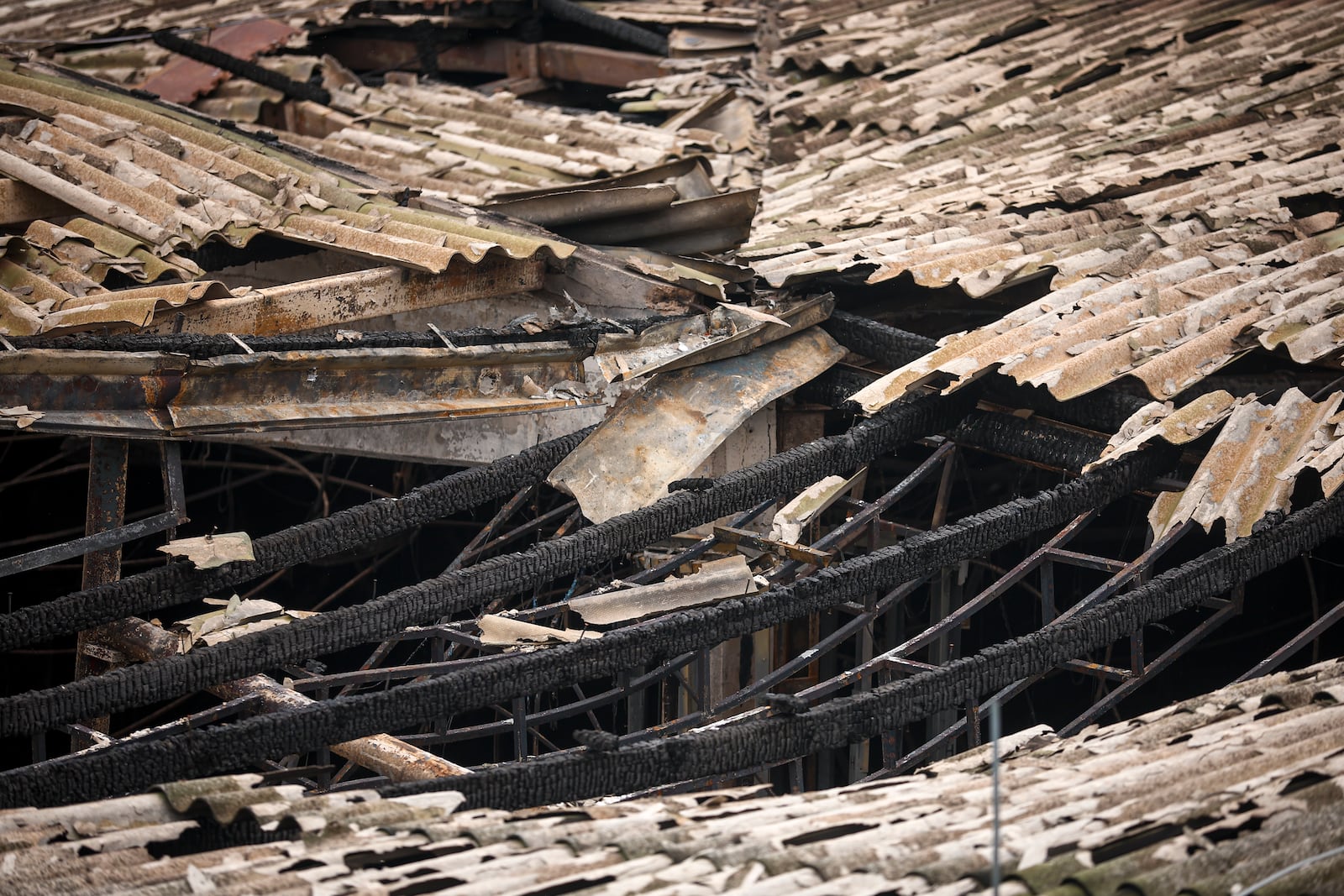 Support beams are charred in the partially collapsed roof of the building of a nightclub, damaged following a massive fire early Sunday in the town of Kocani, North Macedonia, Monday, March 17, 2025, (AP Photo/Armin Durgut)