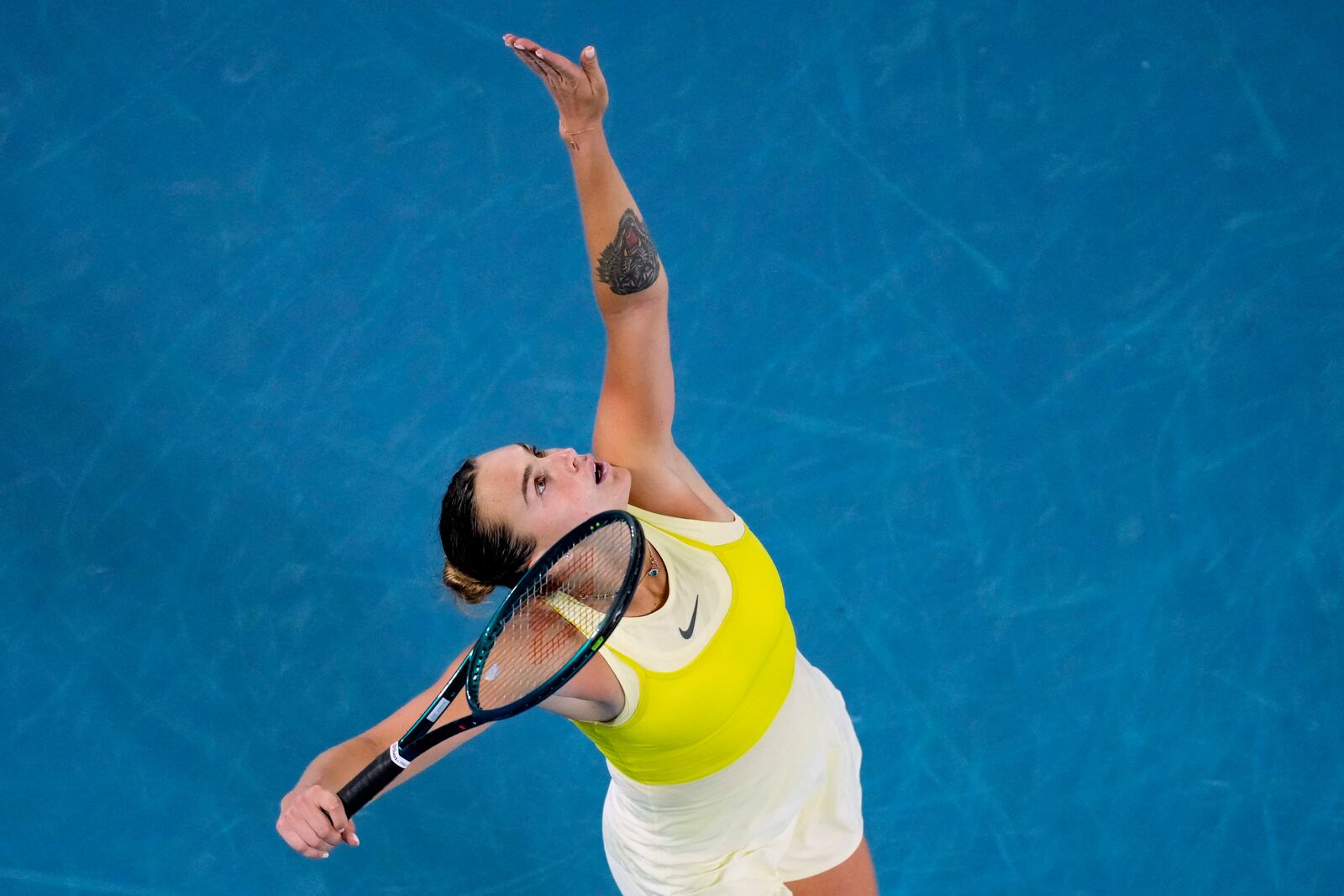 Aryna Sabalenka of Belarus serves to Paula Badosa of Spain during their semifinal match at the Australian Open tennis championship in Melbourne, Australia, Thursday, Jan. 23, 2025. (AP Photo/Vincent Thian)