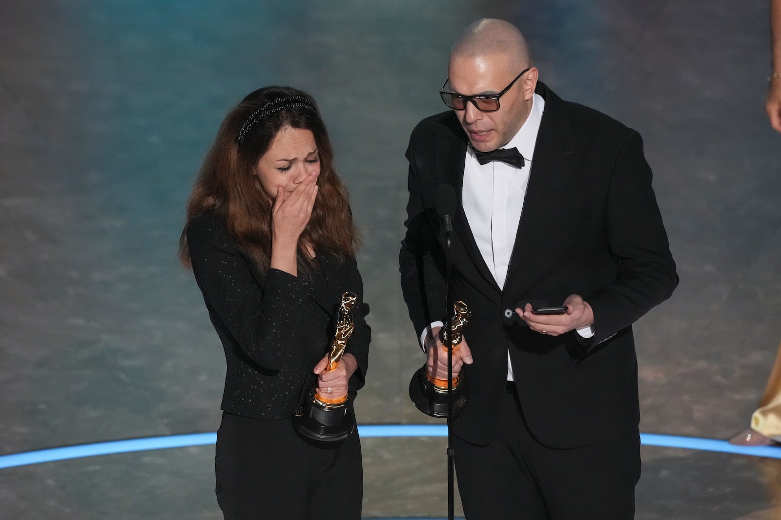 Shirin Sohani, left, and Hossein Molayemi accept the award for best animated short for "In the Shadow of the Cypress" during the Oscars on Sunday, March 2, 2025, at the Dolby Theatre in Los Angeles. (AP Photo/Chris Pizzello)