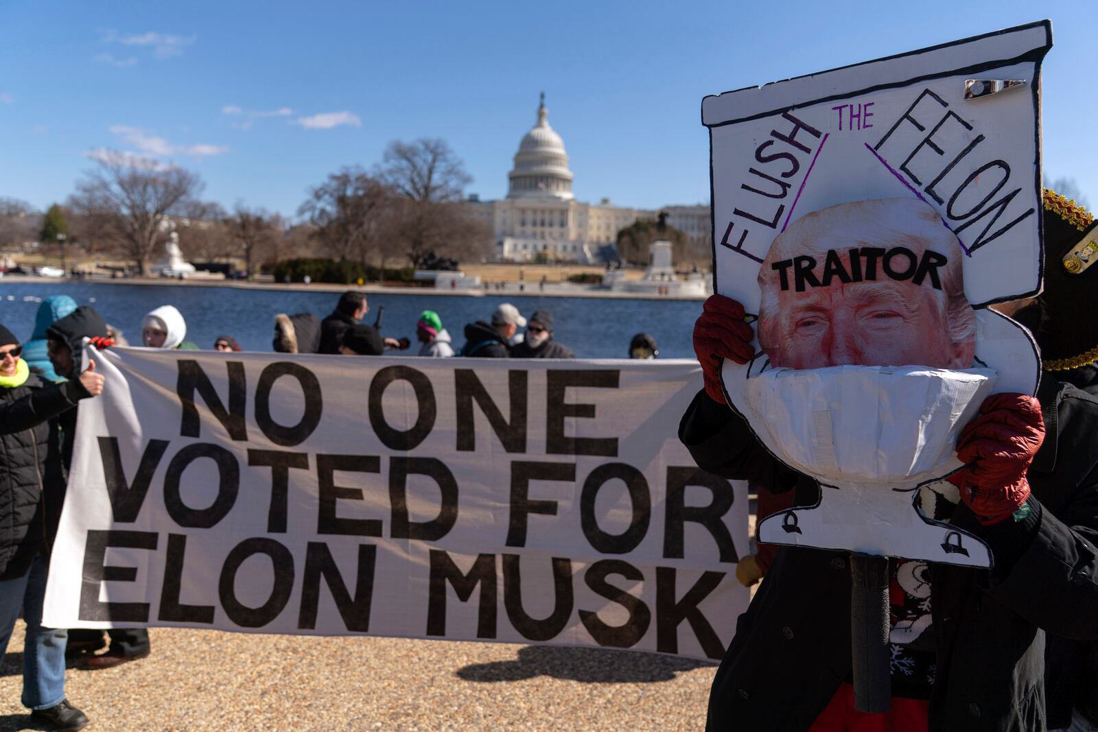 Demonstrators rally during the "No Kings Day" protest on Presidents Day in Washington, in support of federal workers and against recent actions by President Donald Trump and Elon Musk, on Capitol Hill in Washington Monday, Feb. 17, 2025. (AP Photo/Jose Luis Magana)